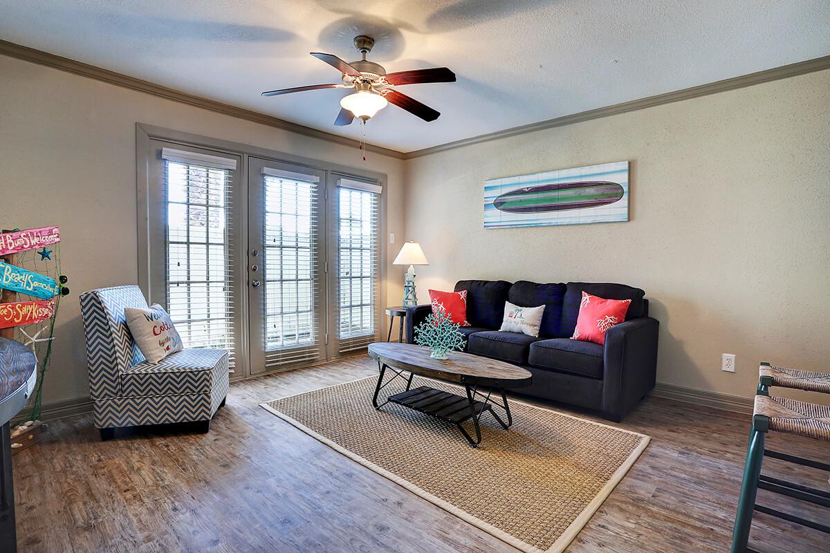 a living room filled with furniture and a large window