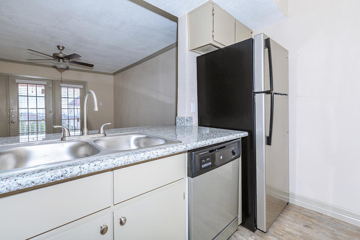 a kitchen with a sink and a mirror