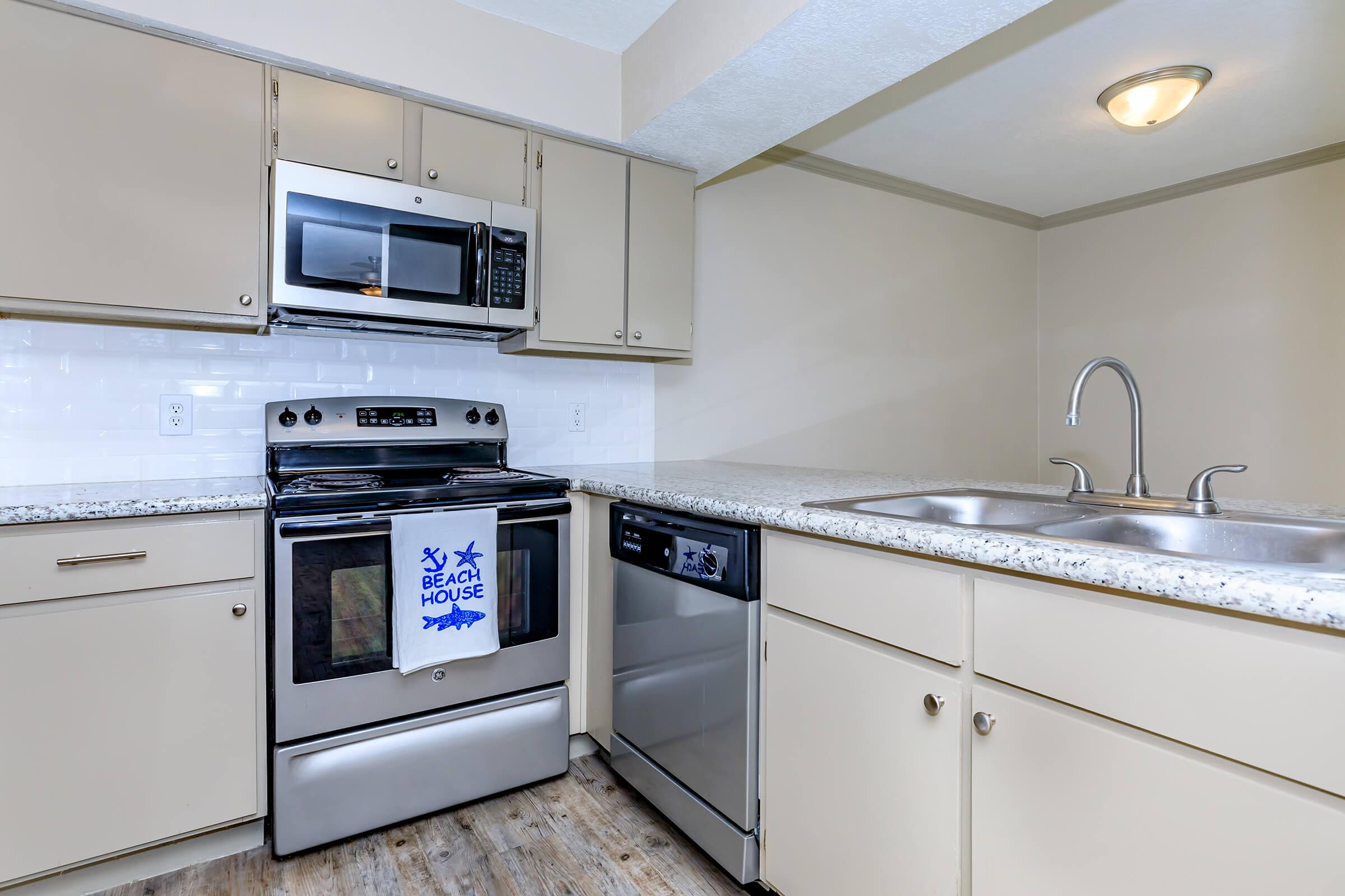 a white stove top oven sitting inside of a kitchen