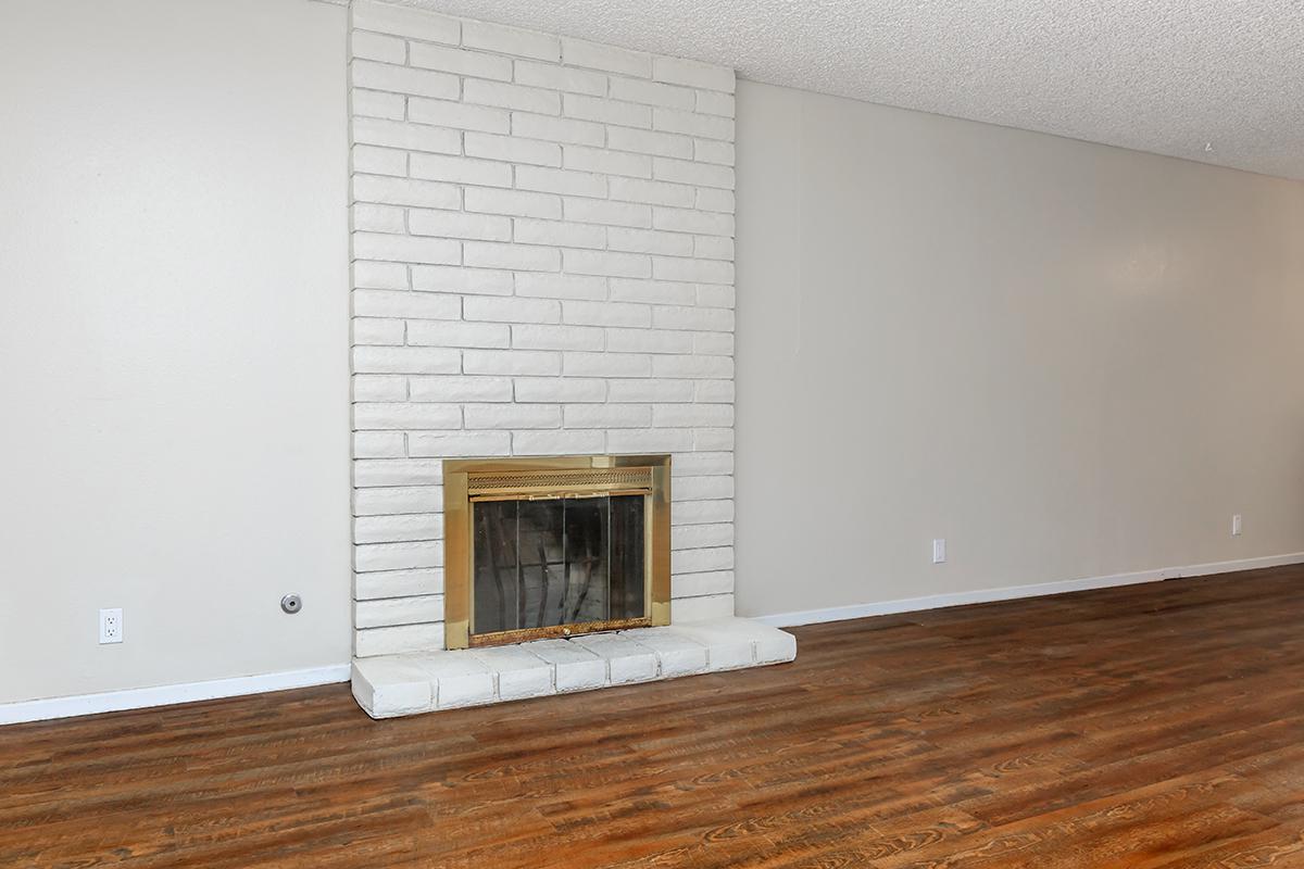 a close up of a hard wood floor next to a fireplace