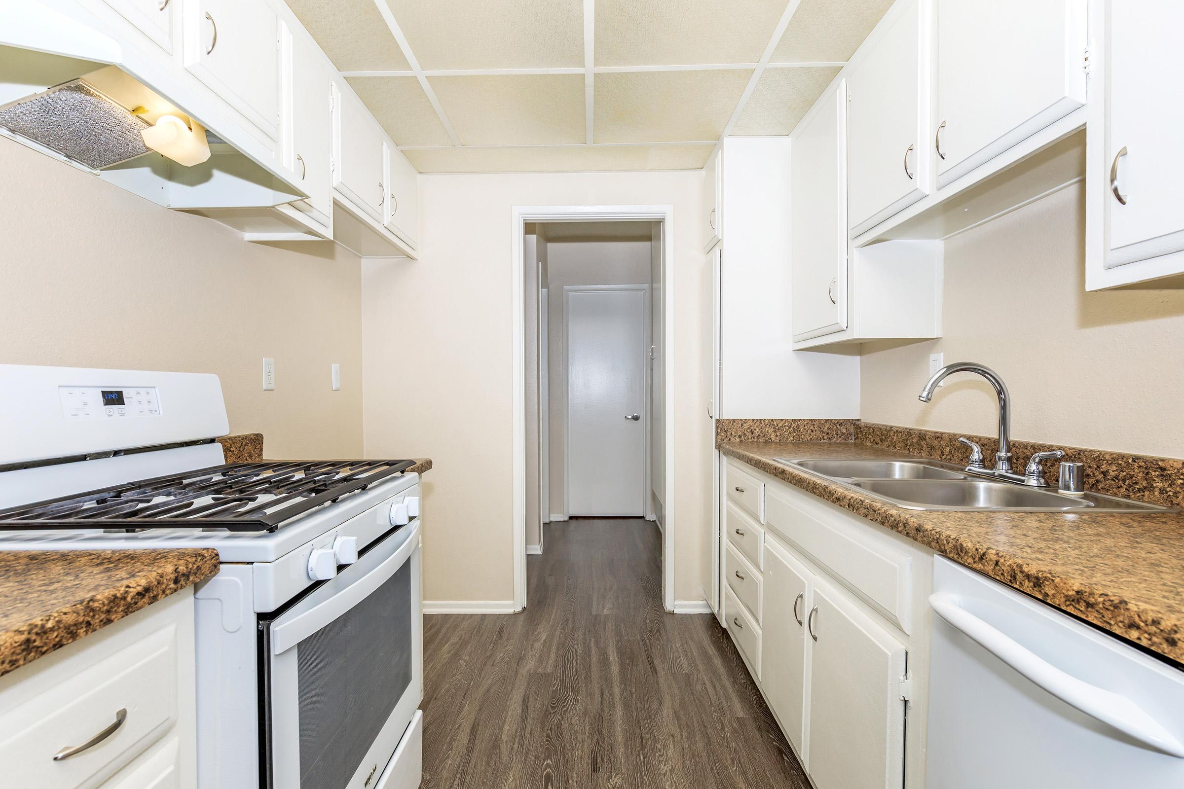 a kitchen with a stove and a sink