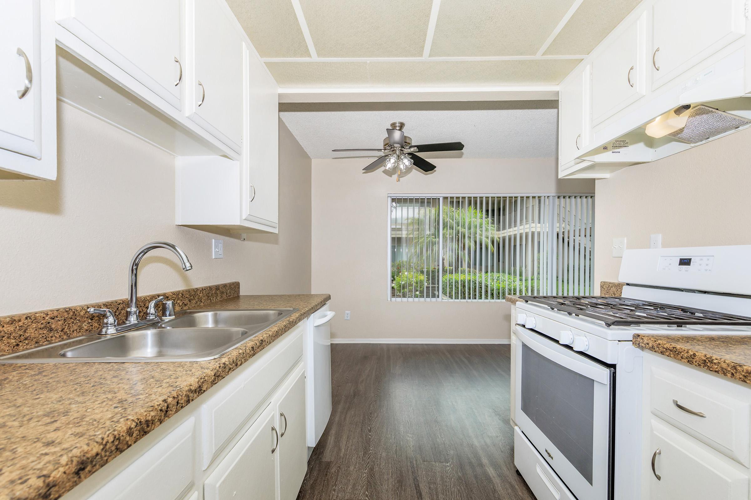 a kitchen with a stove and a sink