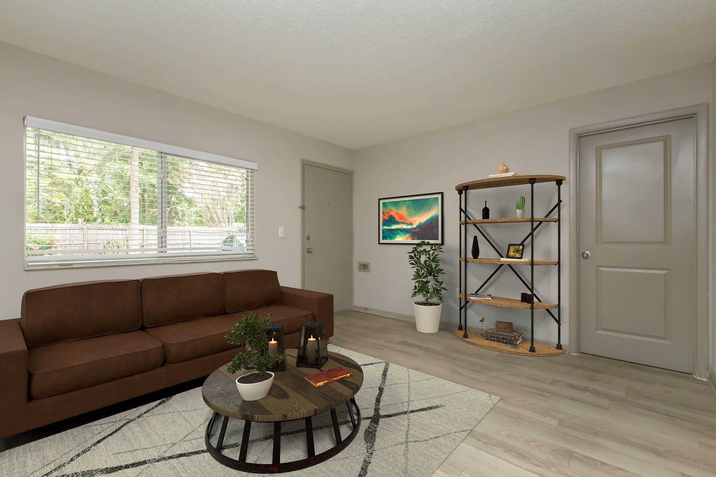 a living room filled with furniture and a large window