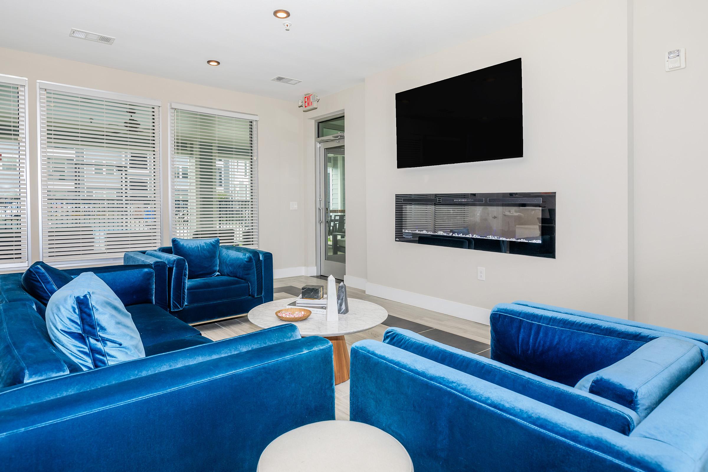 a living room with blue walls and a large window