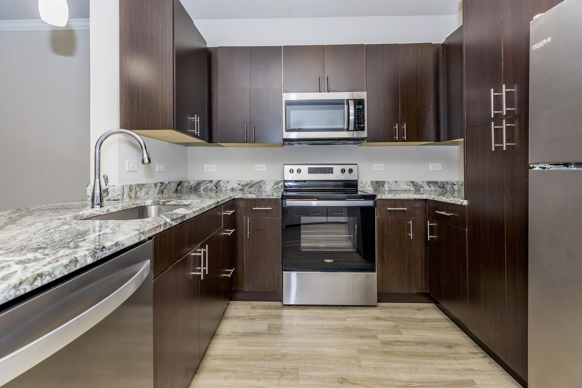 a large kitchen with stainless steel appliances