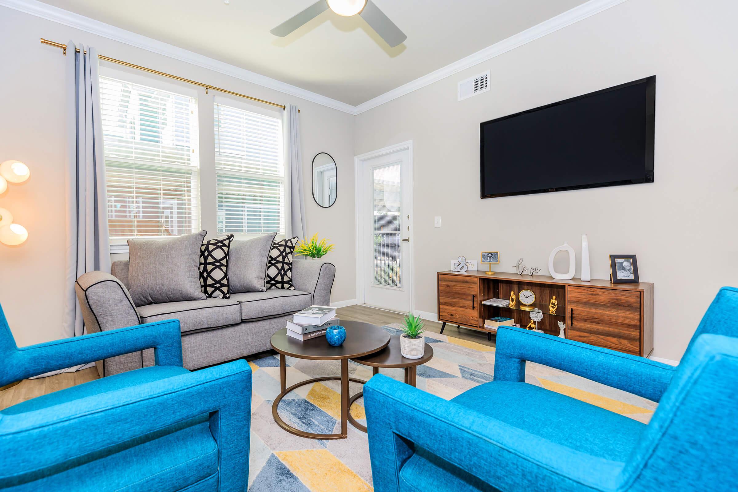 a living room filled with furniture and a large window