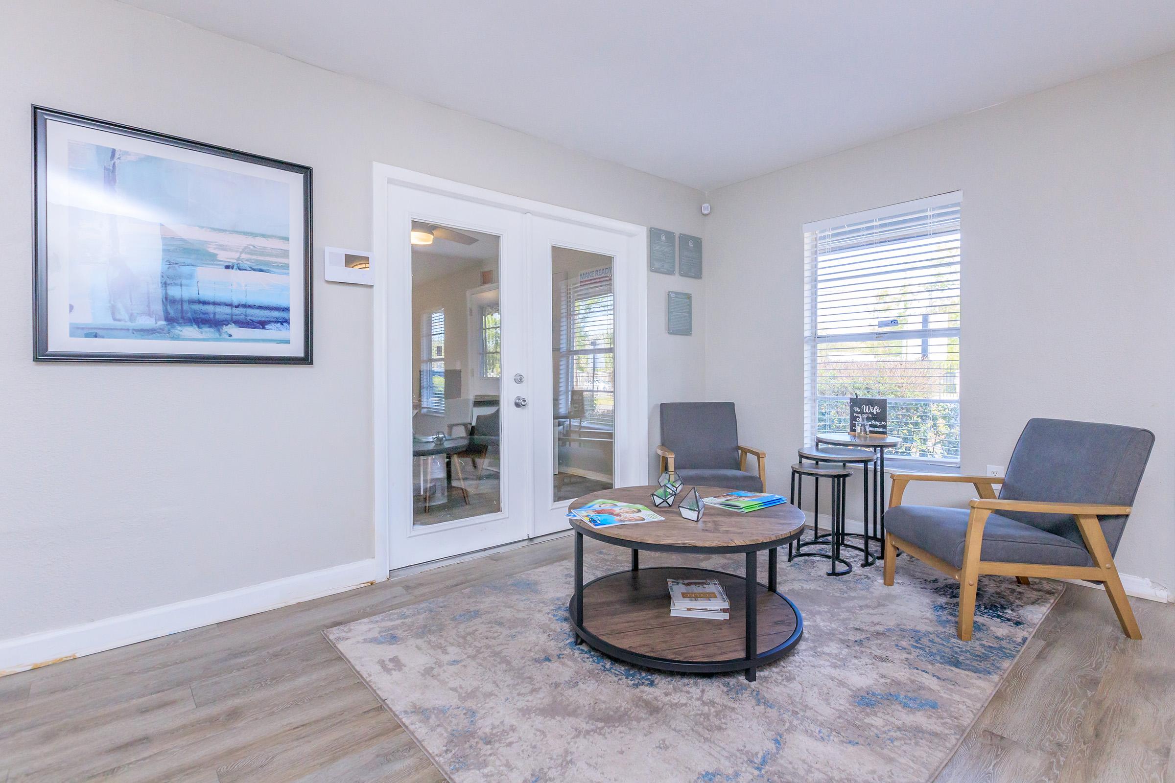 a living room filled with furniture and a large window