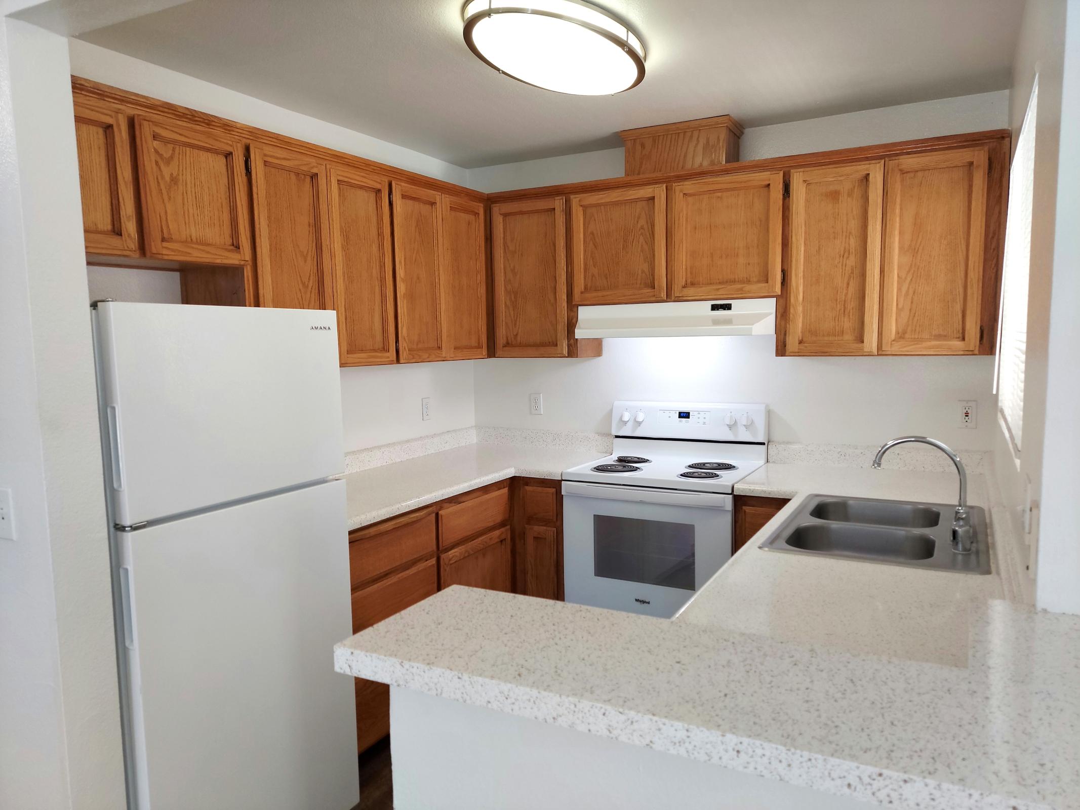 a kitchen with a refrigerator stove and microwave