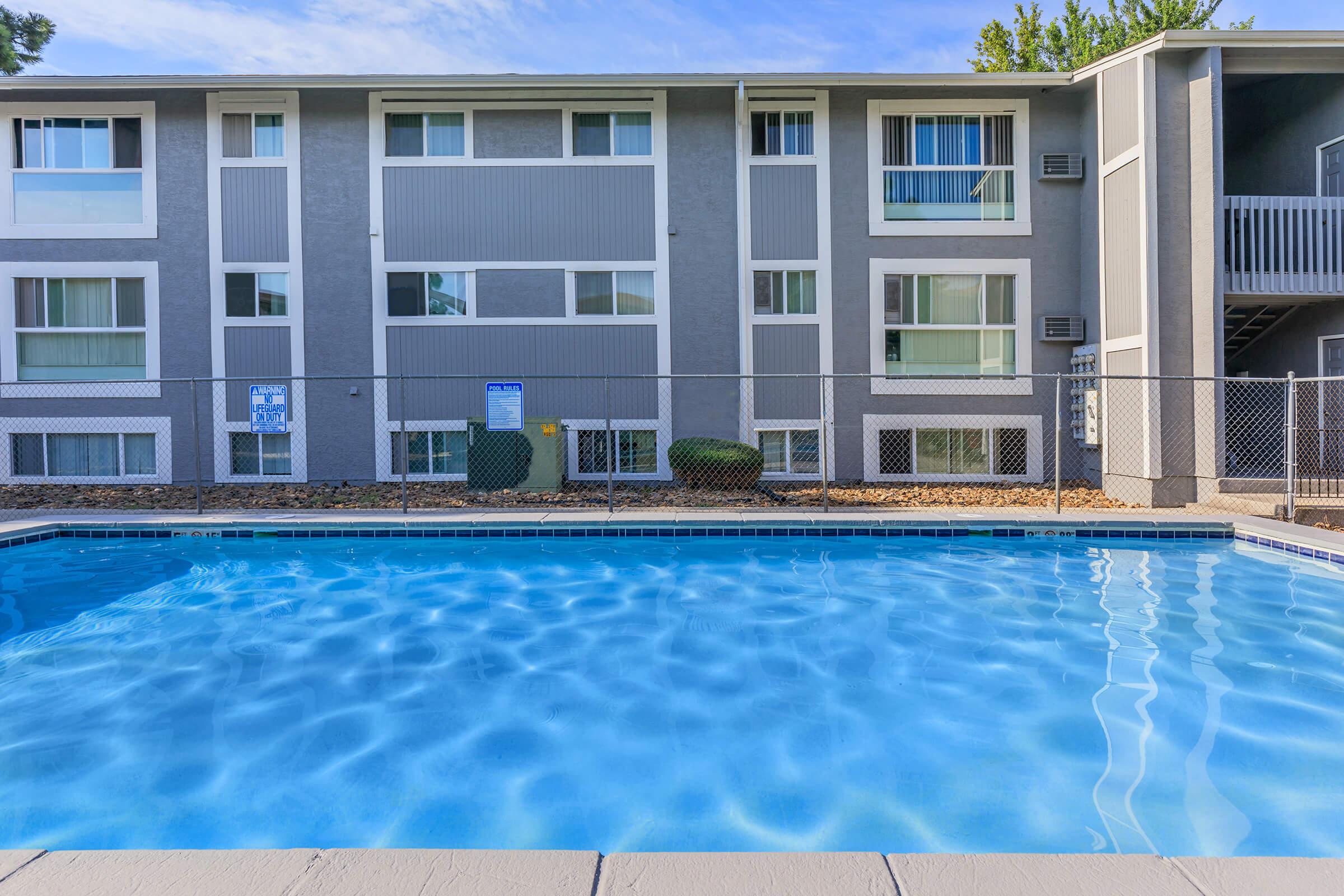 a blue pool of water in front of a building