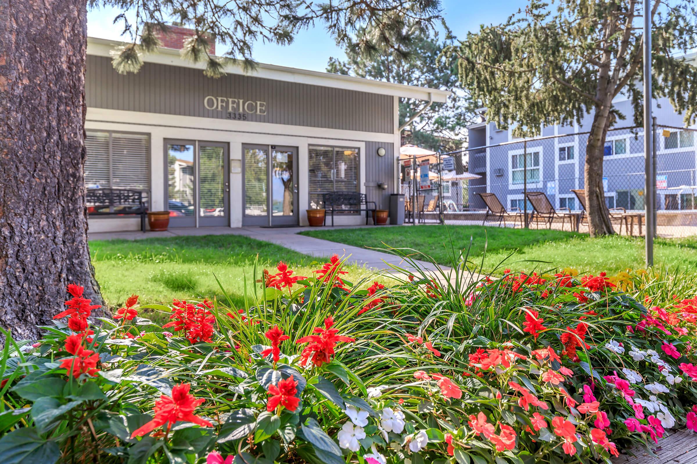 a colorful flower garden in front of a building