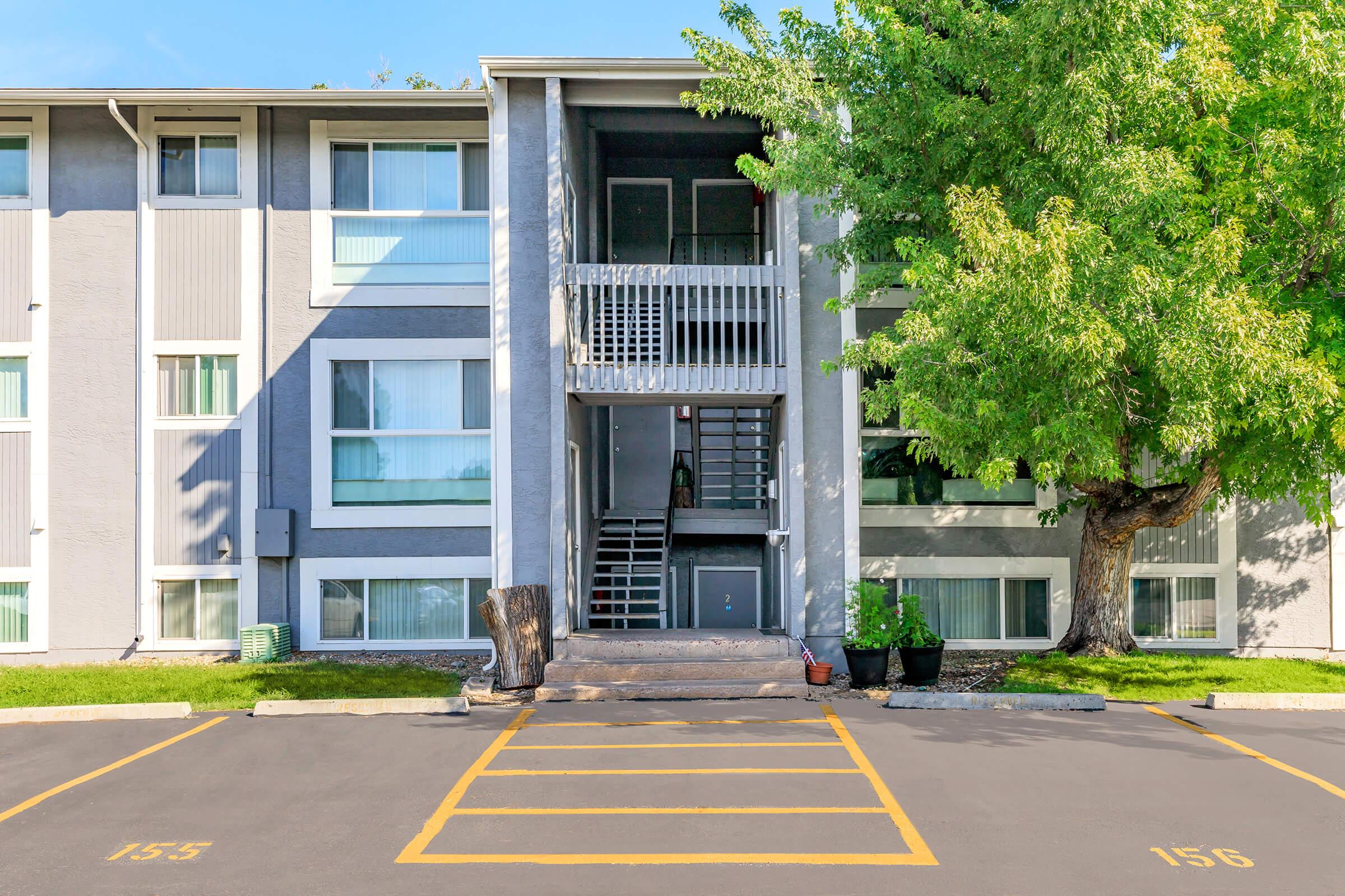 an empty parking lot in front of a house