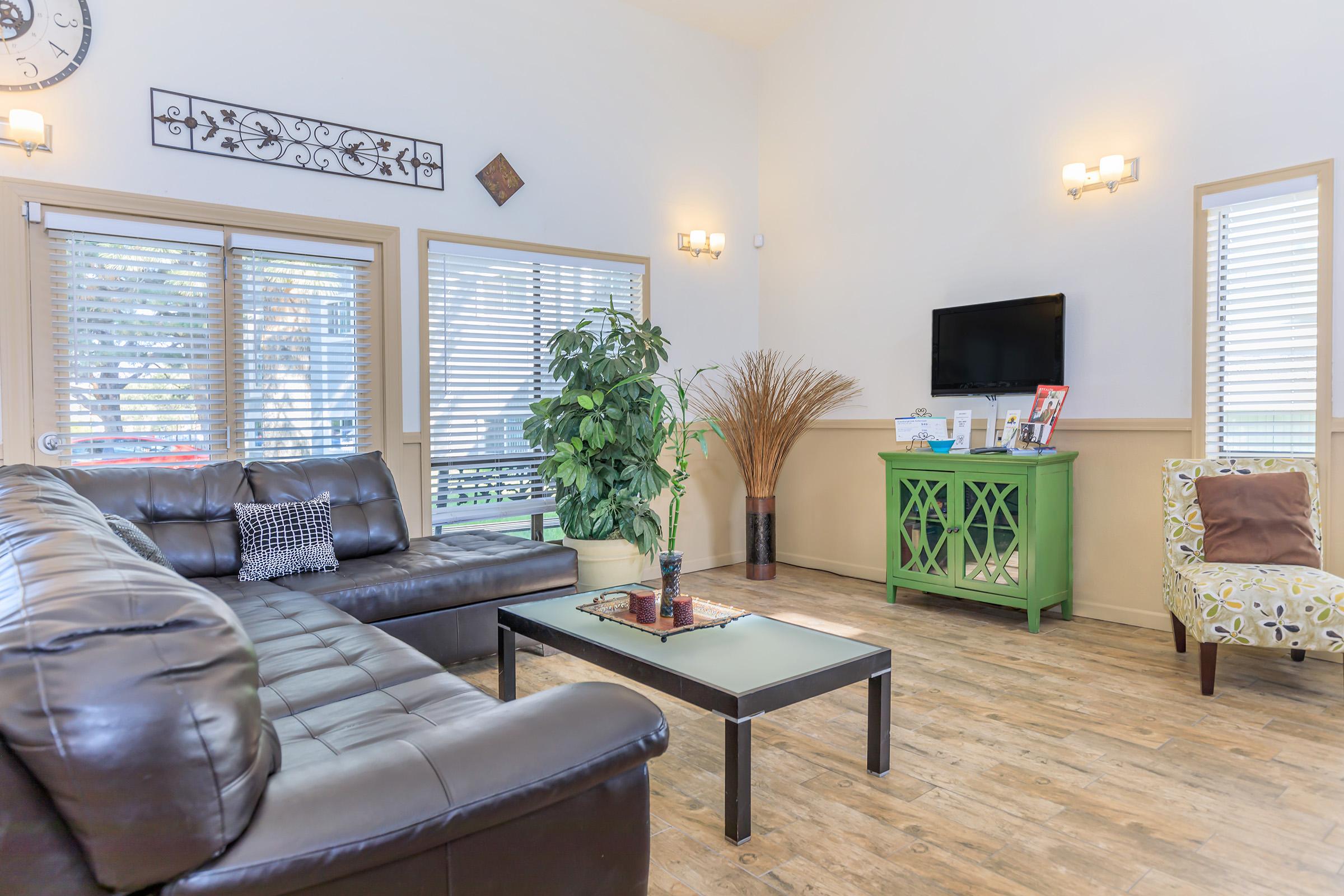 a living room filled with furniture and a large window