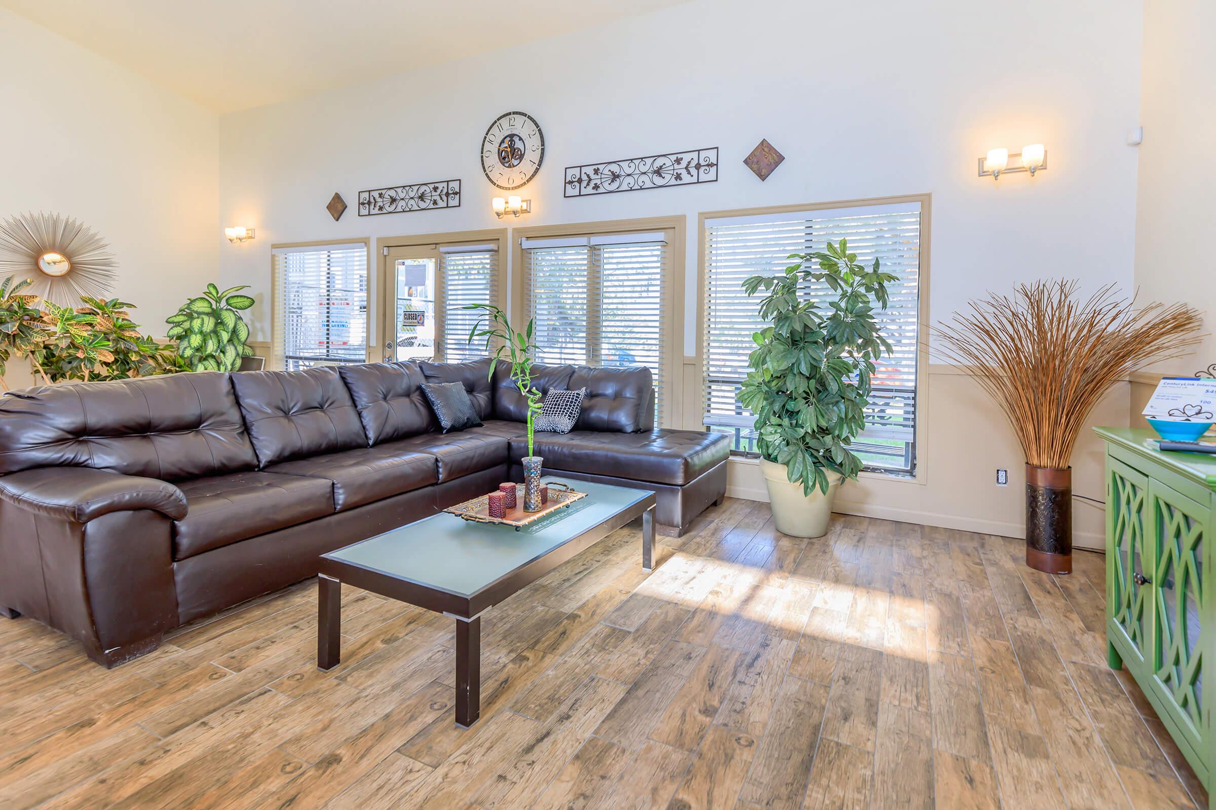 a living room filled with furniture and a large window