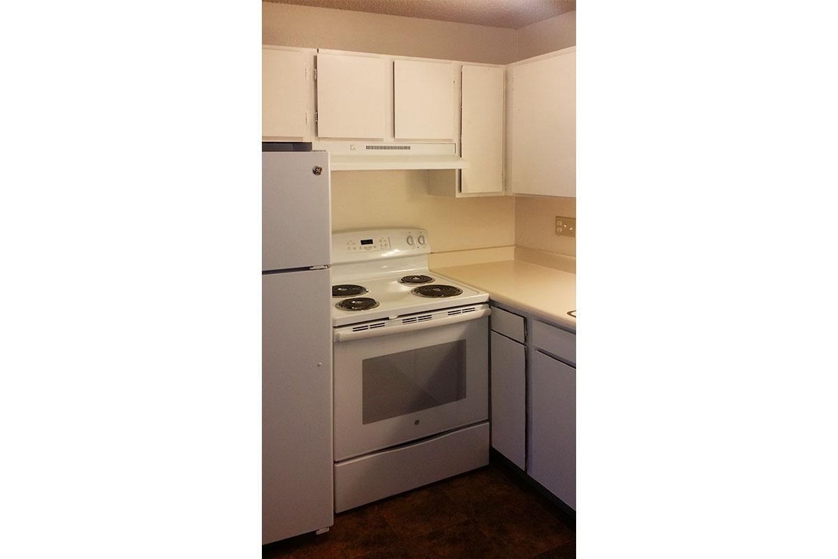 a stove top oven sitting inside of a kitchen