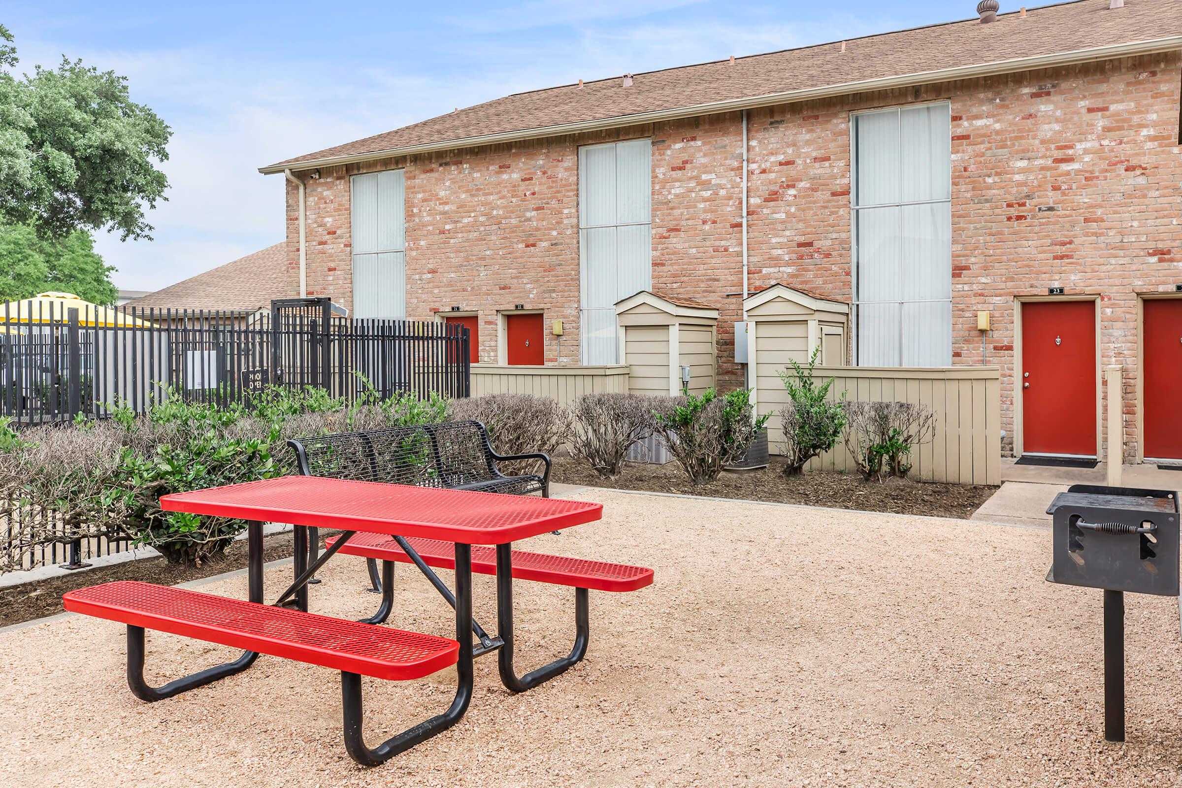 a bench in front of a brick building