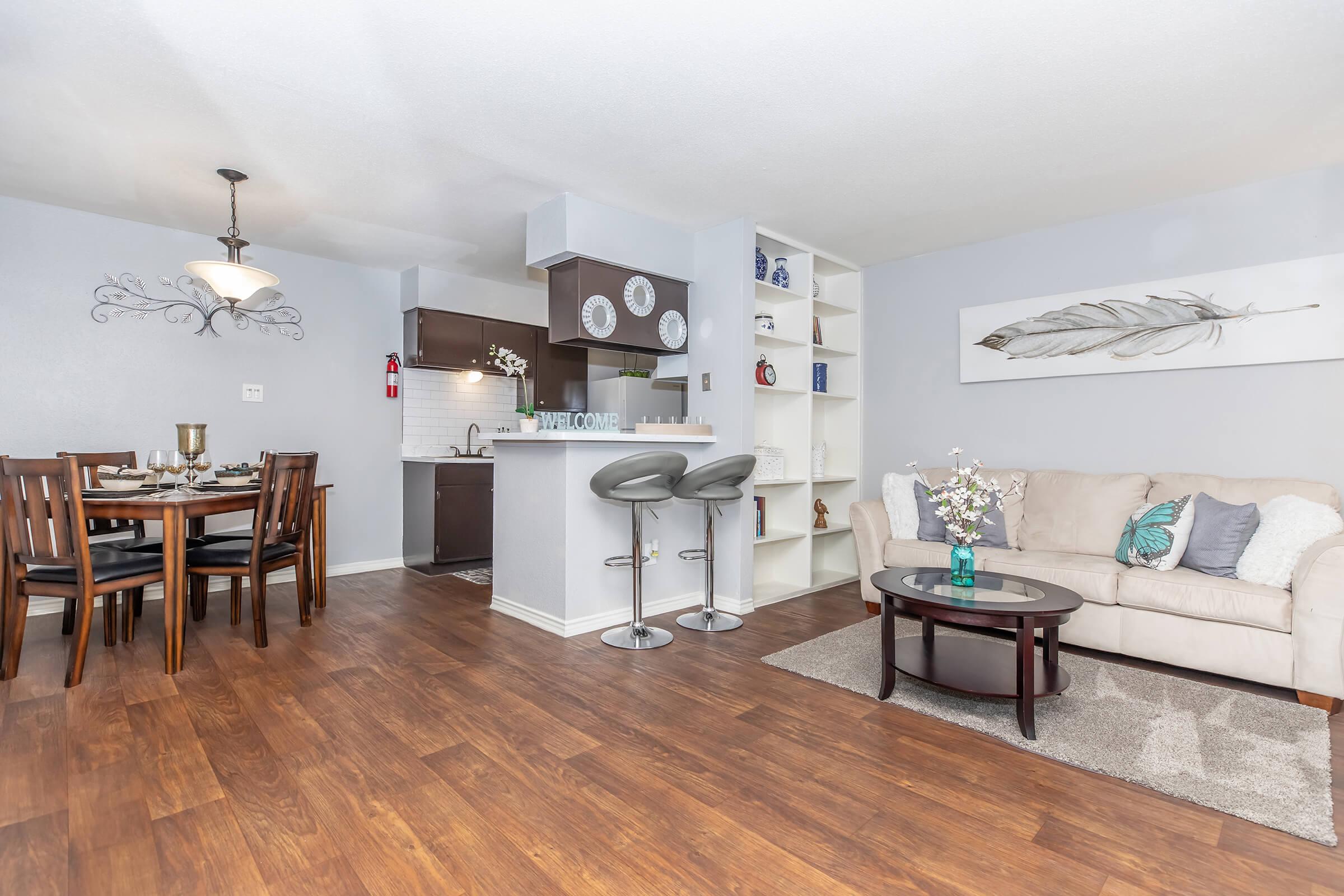 a living room filled with furniture and a wood floor