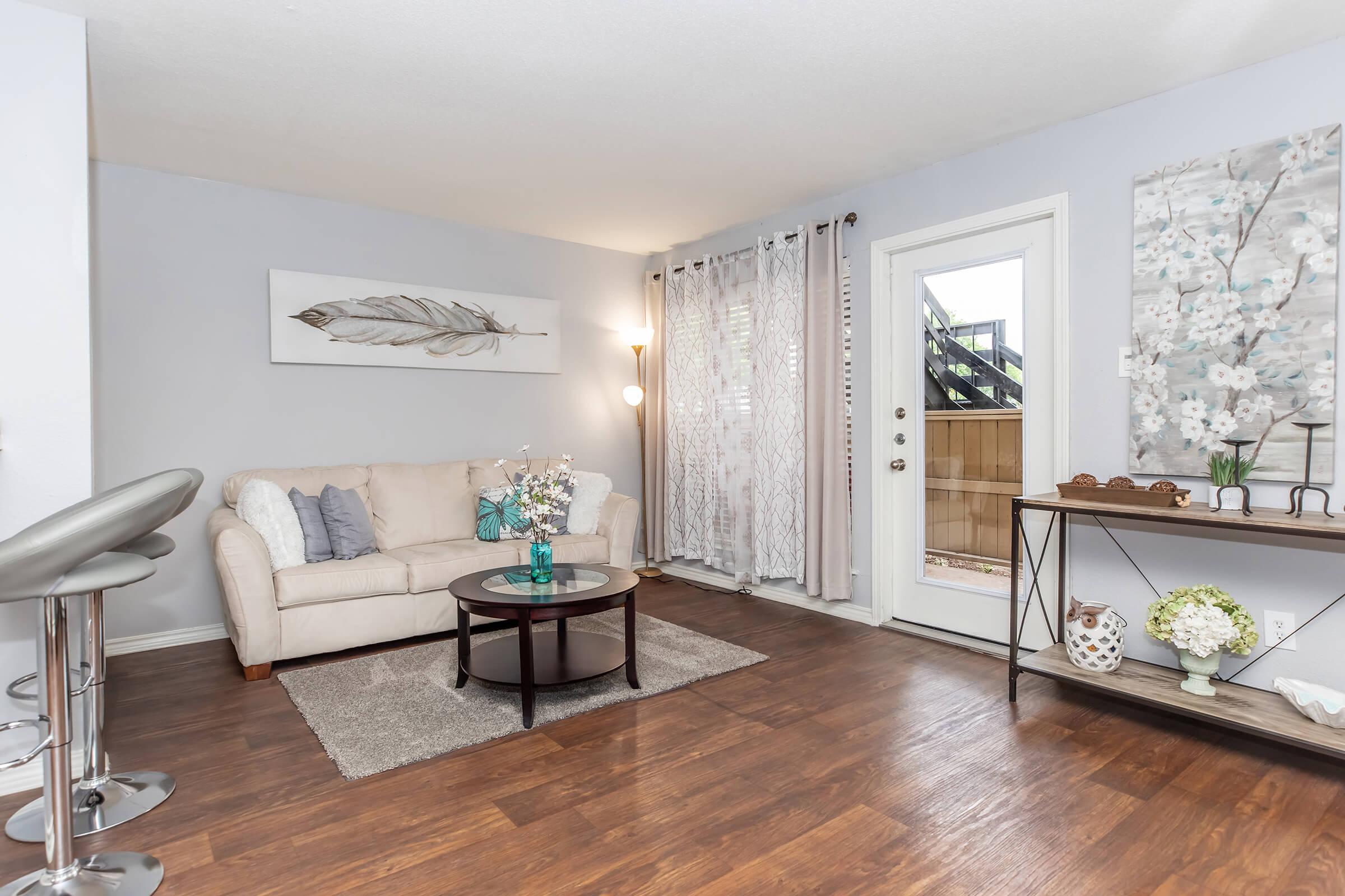 a living room filled with furniture and a large window