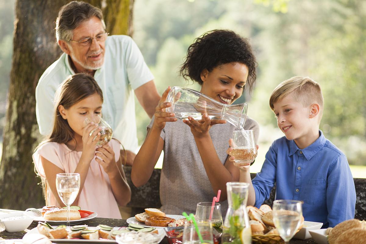 a group of people sitting at a table eating food