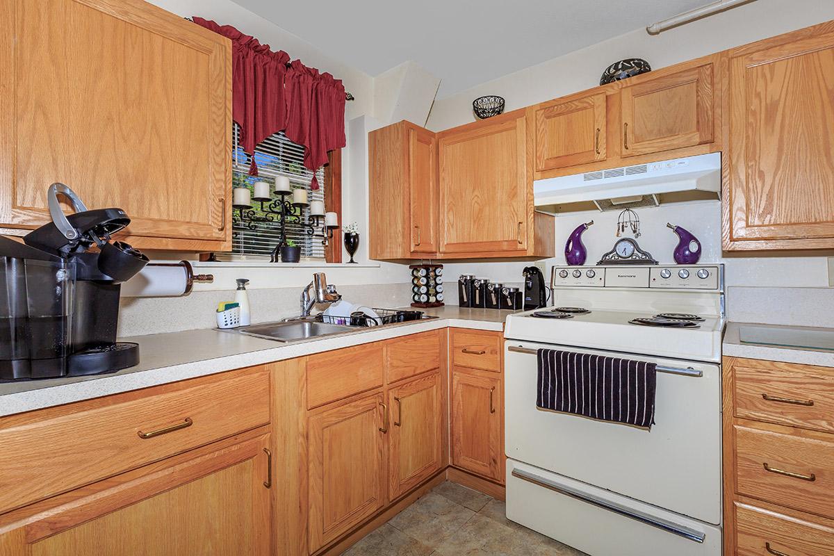 a kitchen with wooden cabinets