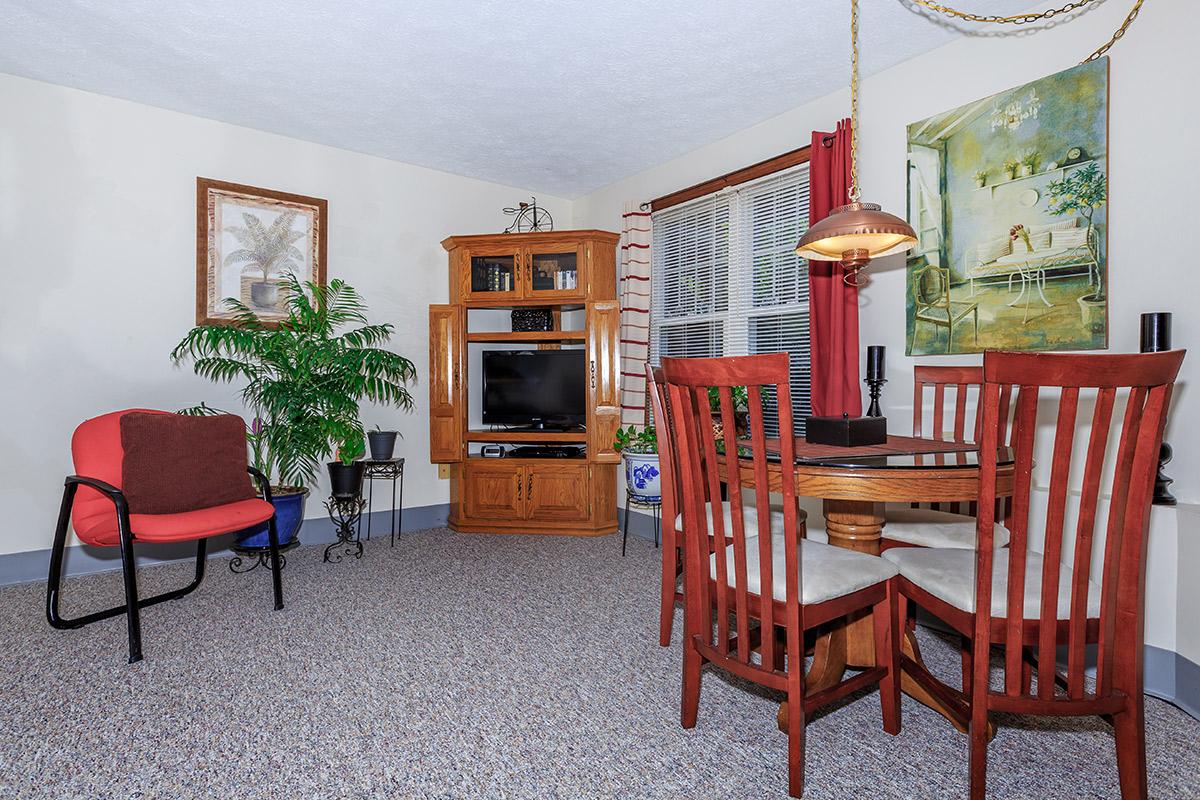 a living room filled with furniture and a fire place sitting in a chair