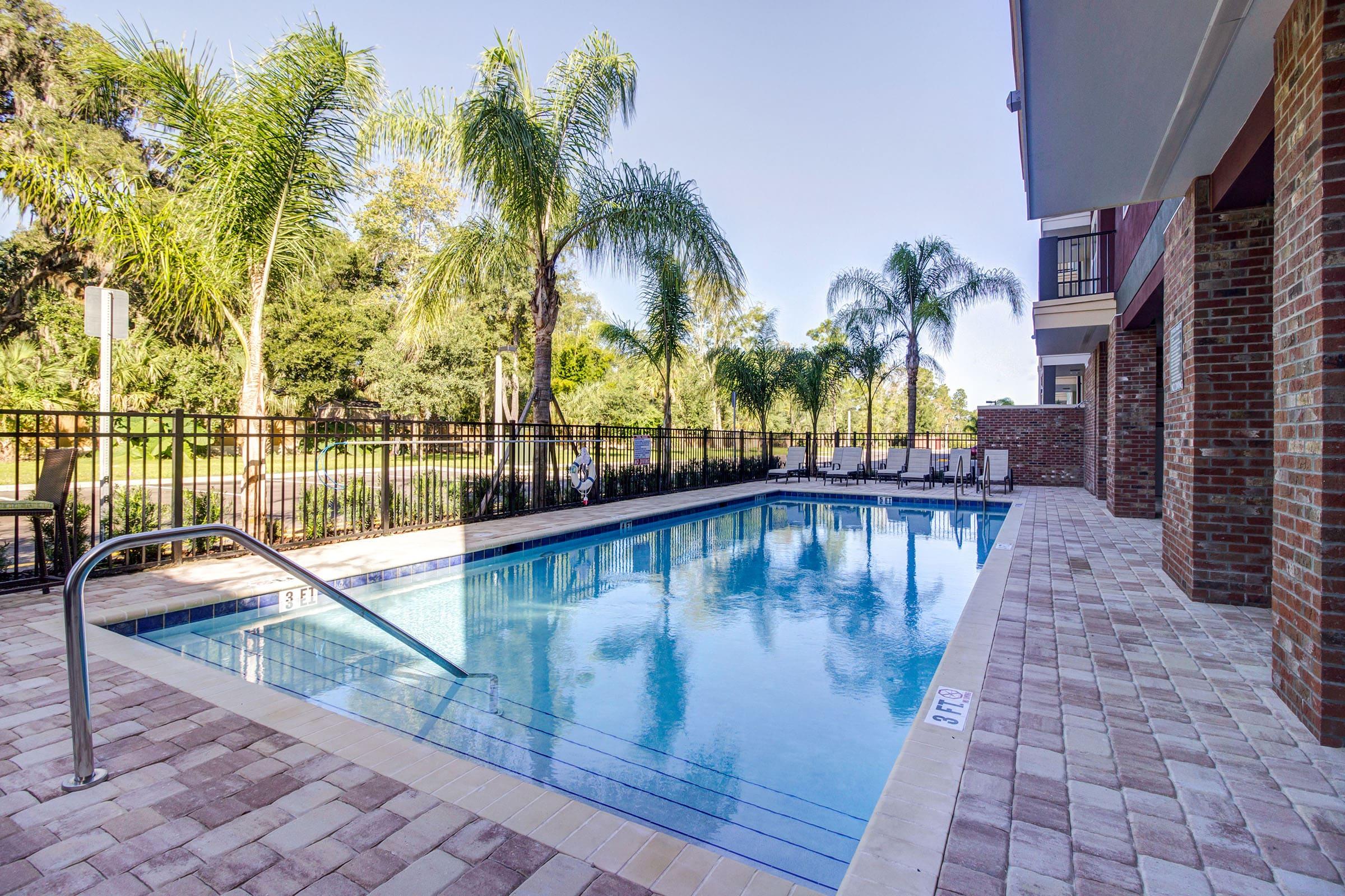 a large brick building with a pool of water