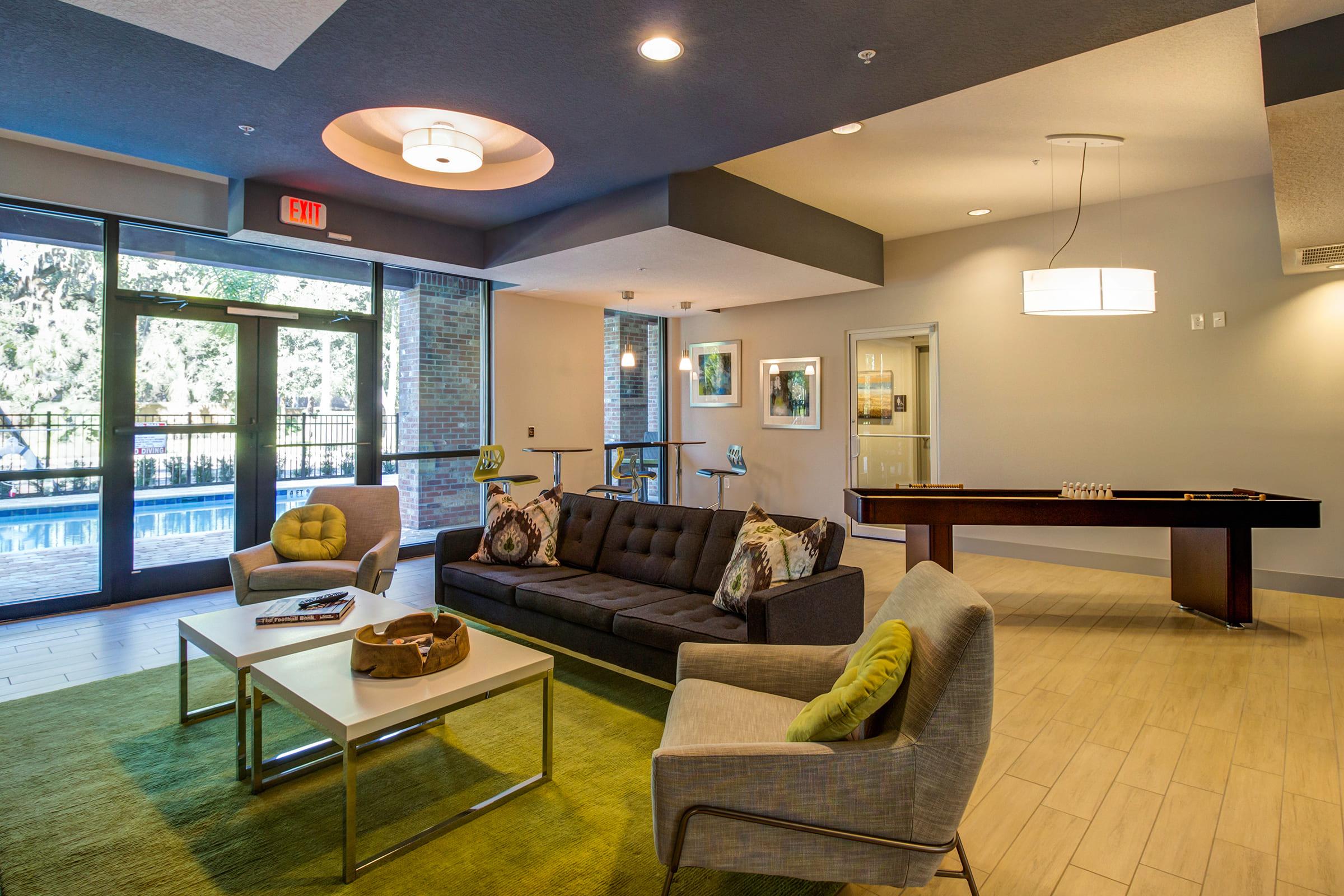 a living room filled with furniture and a large window