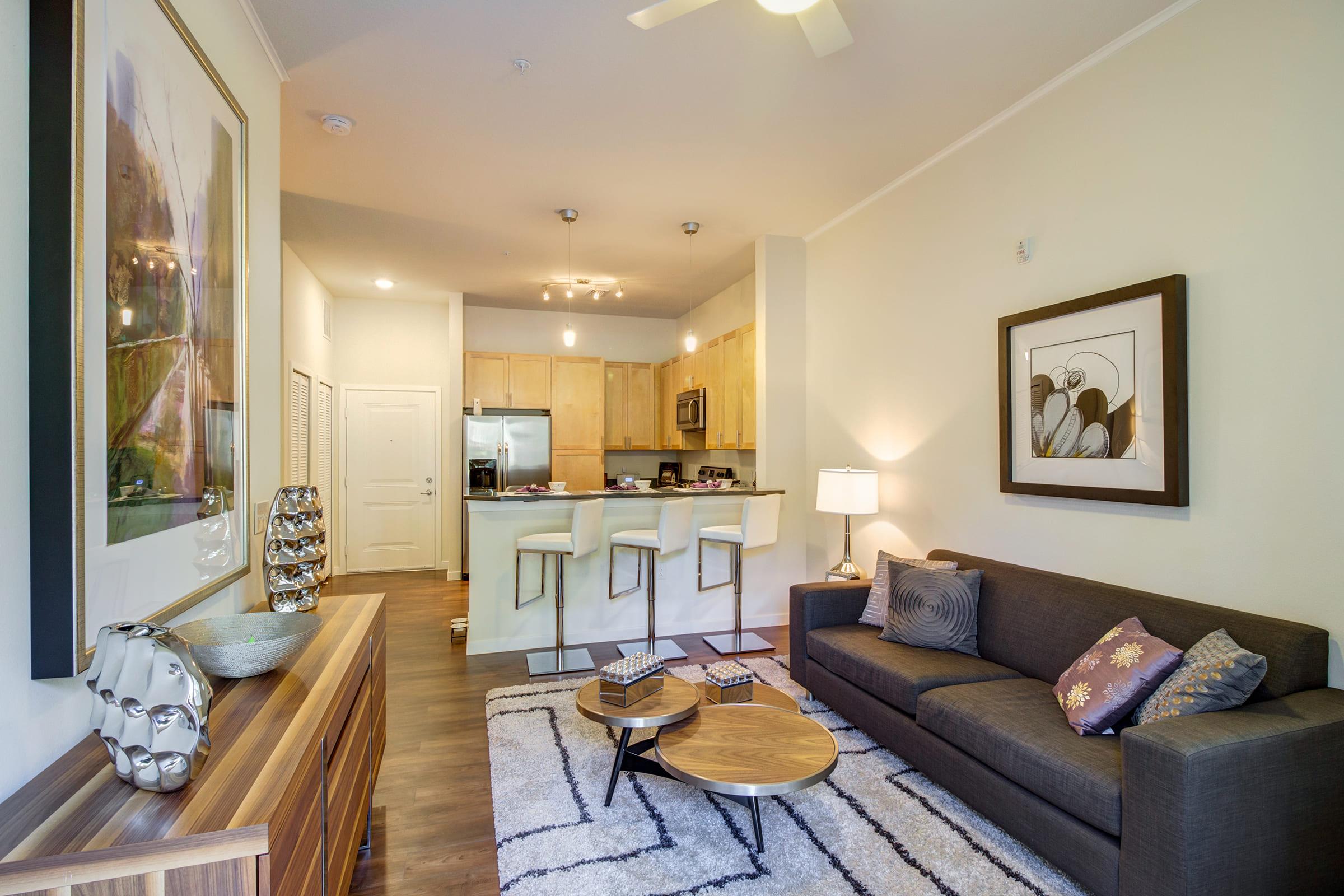 a living room filled with furniture and a large window