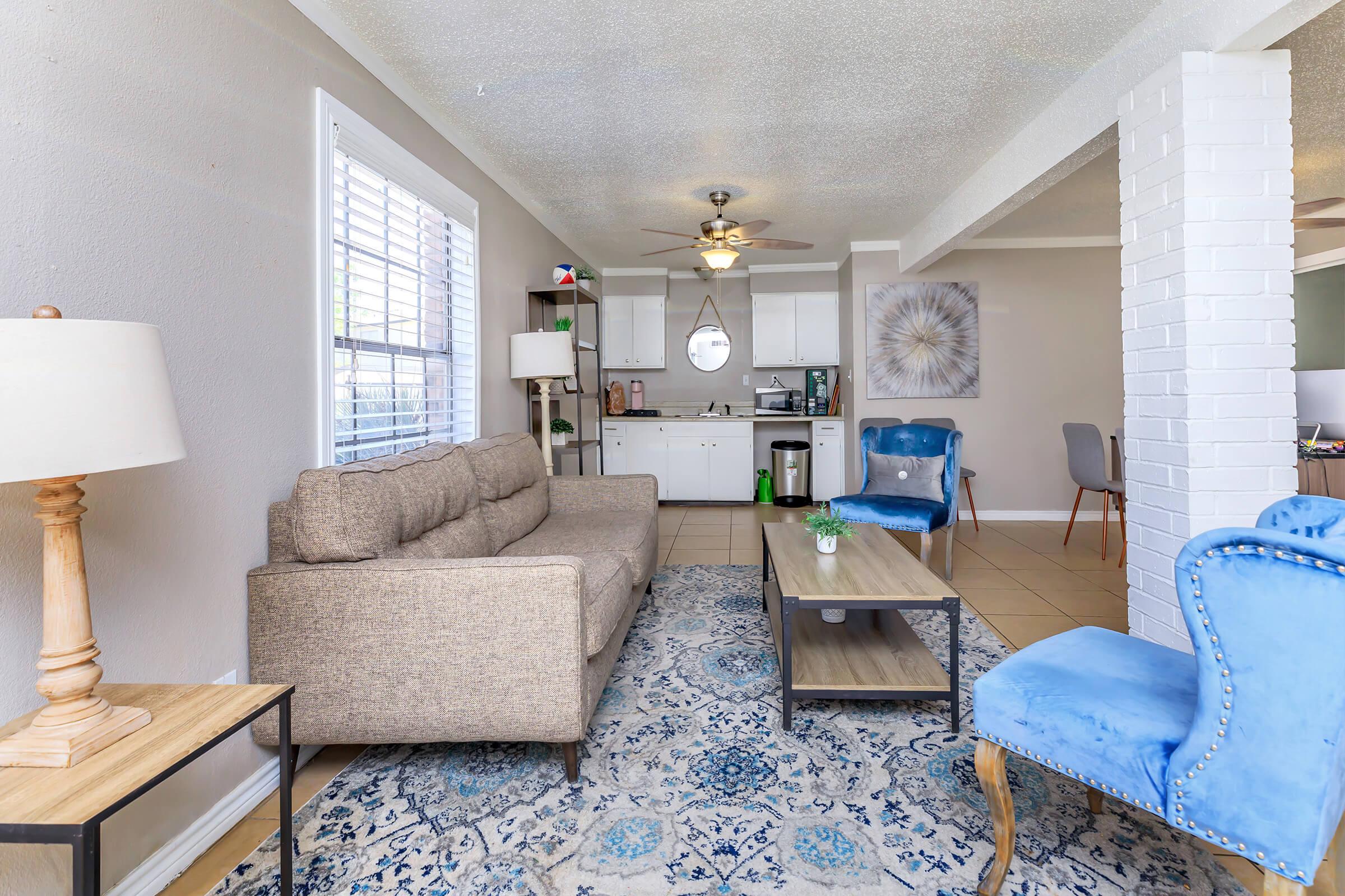 a living room filled with furniture and a rug