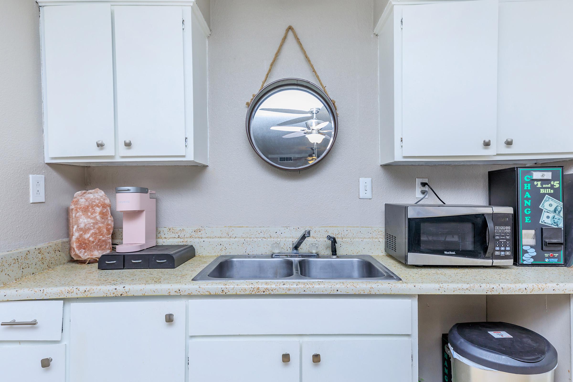 a kitchen with a sink and a microwave