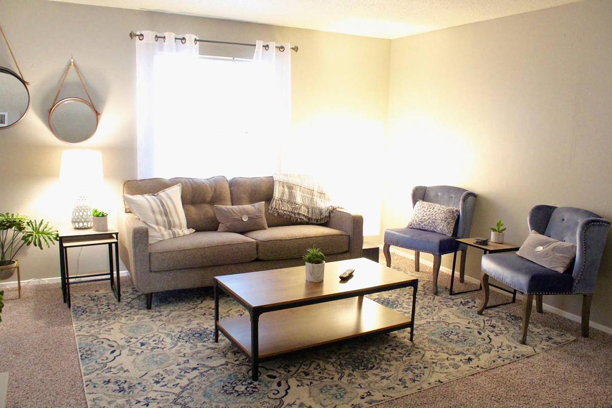 a living room filled with furniture and a lamp