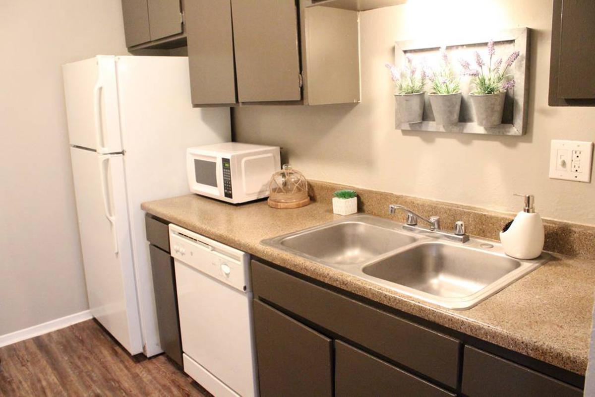 a kitchen with a sink and a mirror