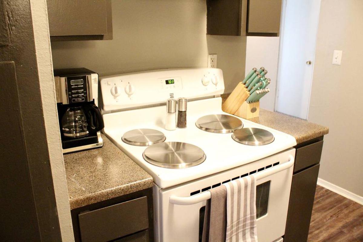 a stove top oven sitting next to a sink