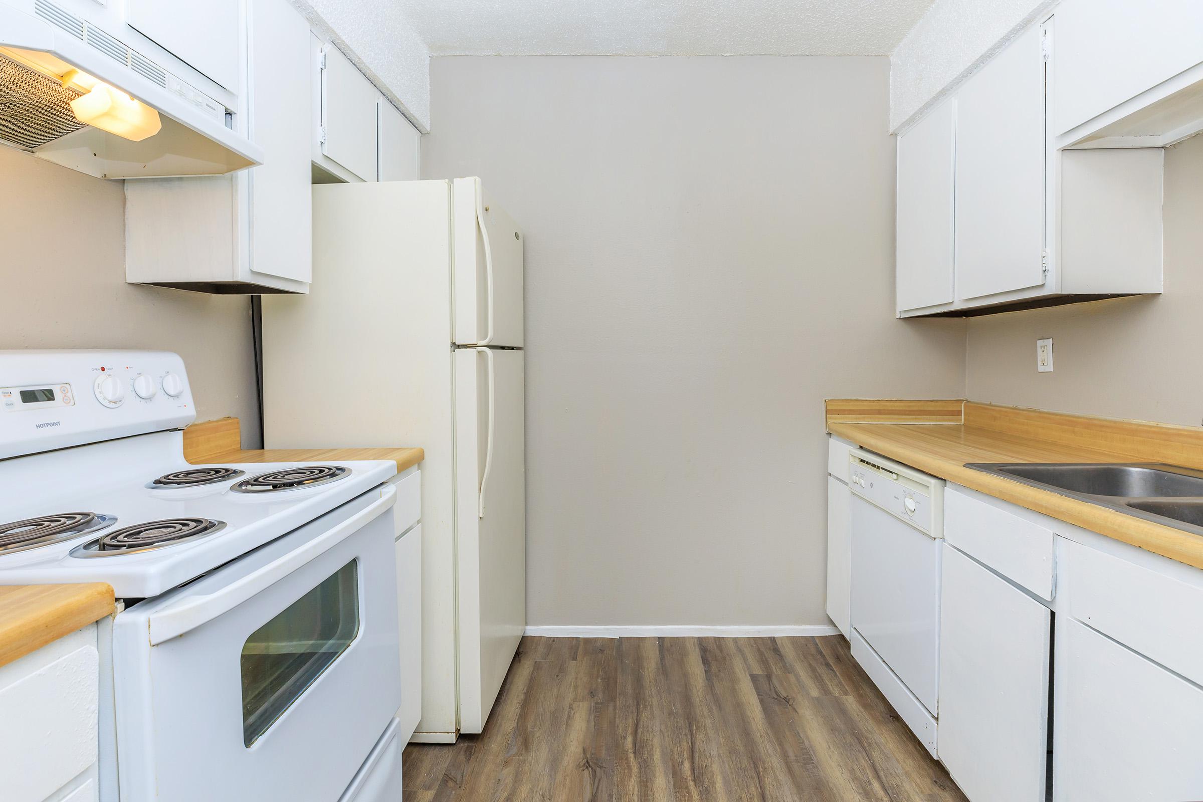 a kitchen with a stove and a refrigerator