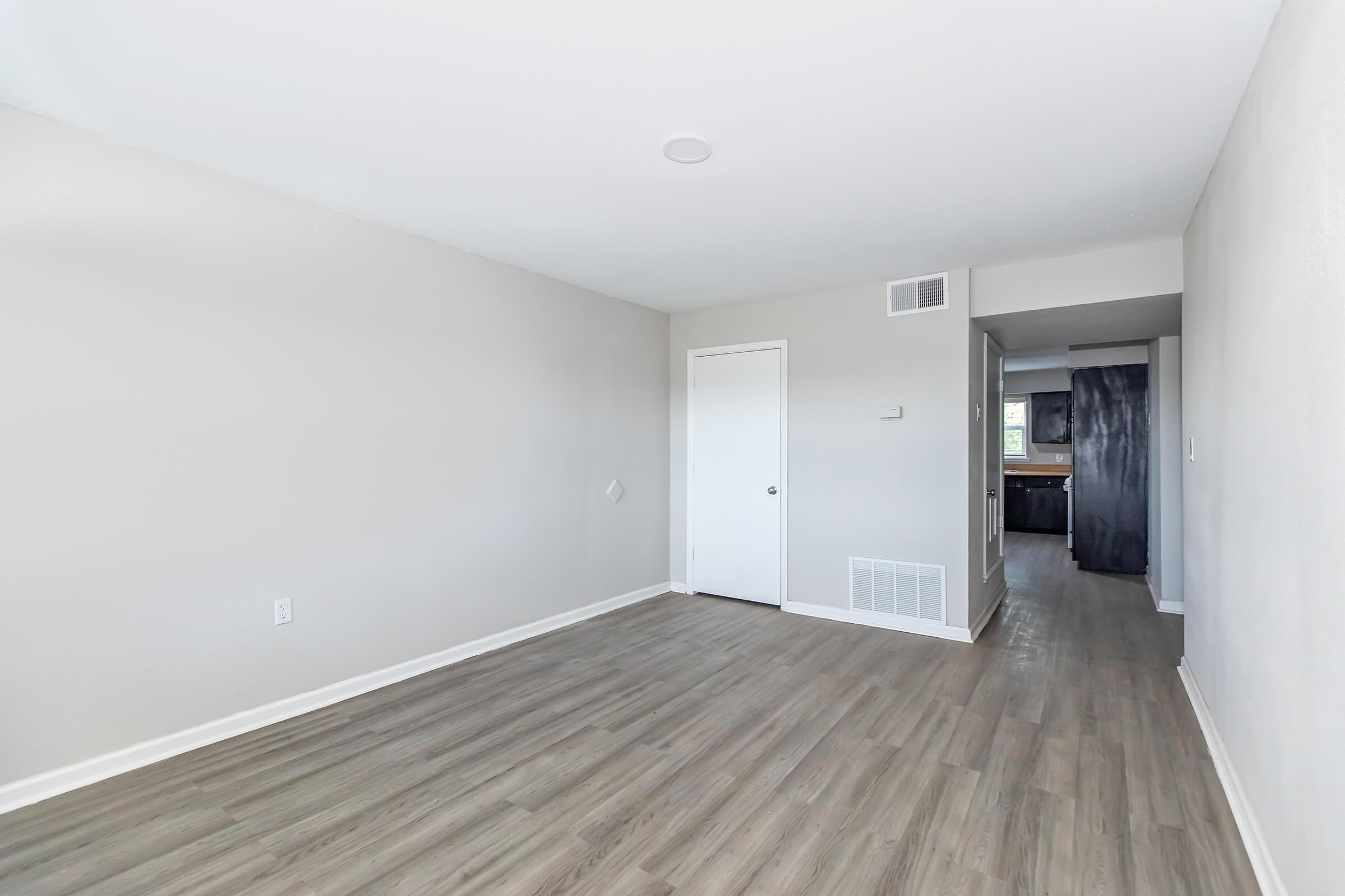 a large empty room with a wood floor