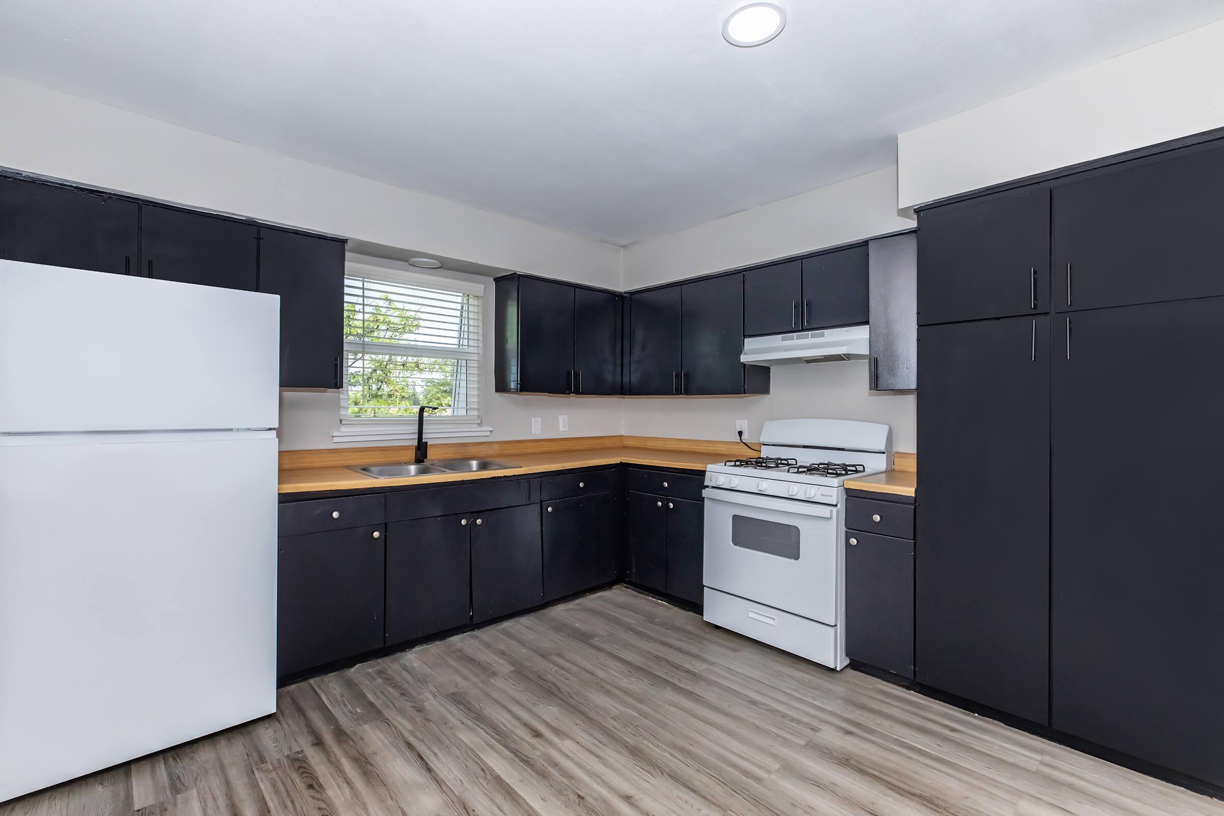 a modern kitchen with stainless steel appliances and wooden cabinets