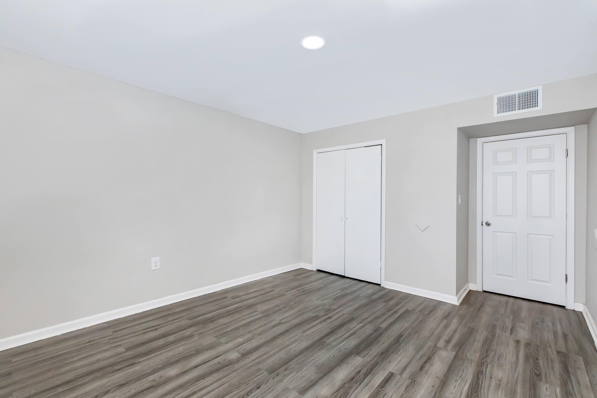 a large empty room with a wooden floor