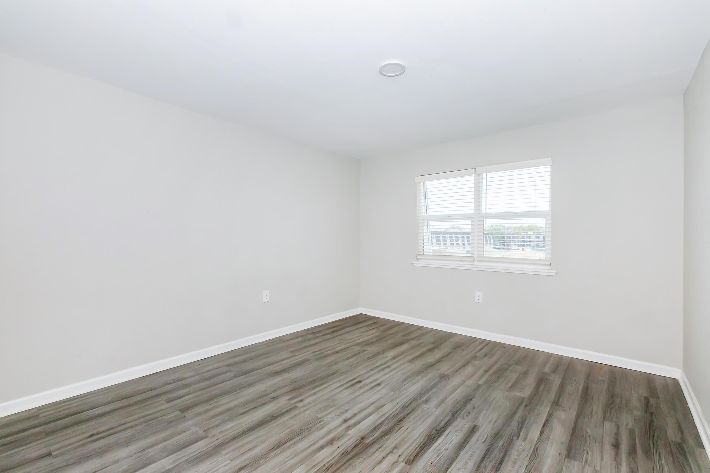 a large empty room with a wooden floor