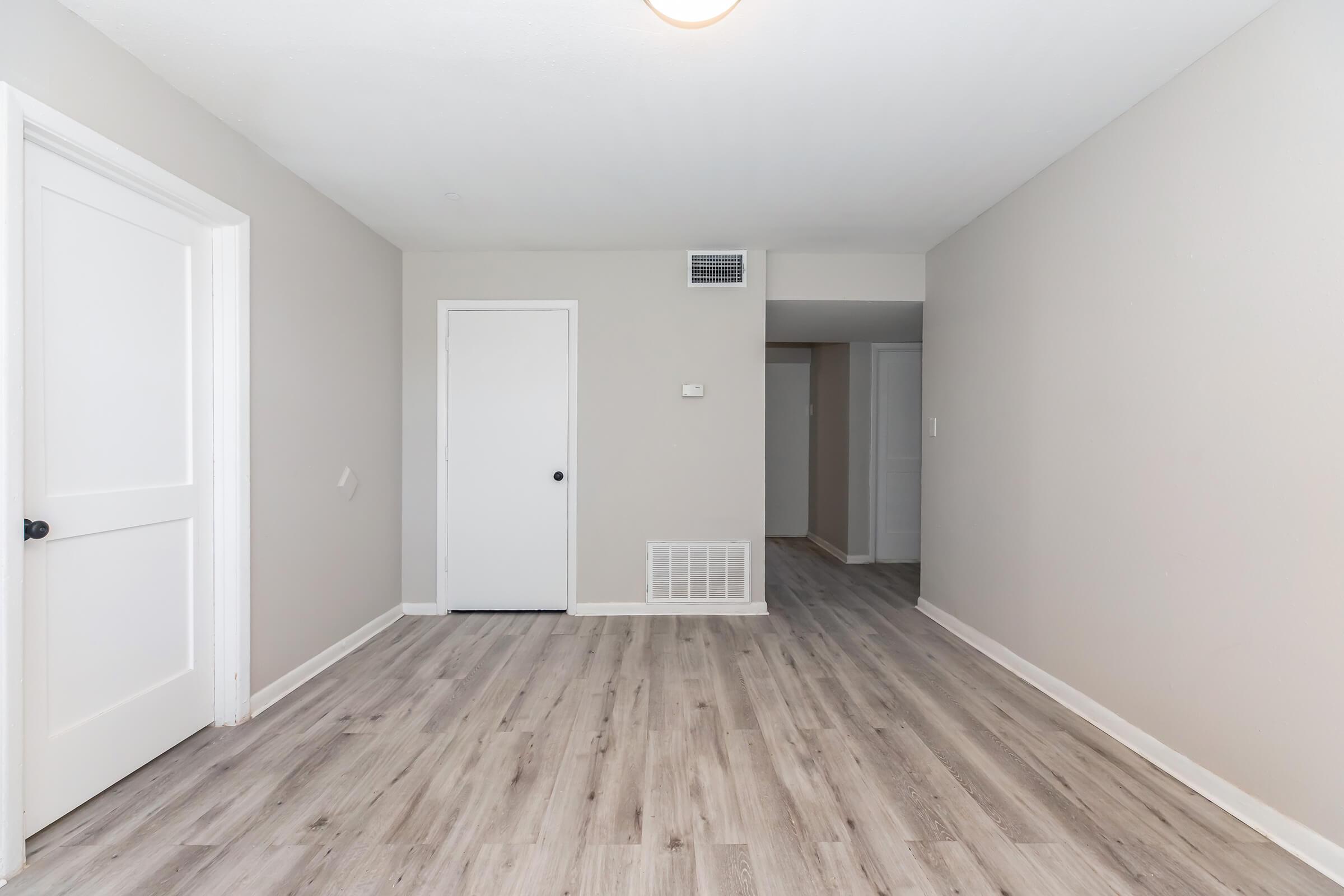 a large empty room with a wooden floor