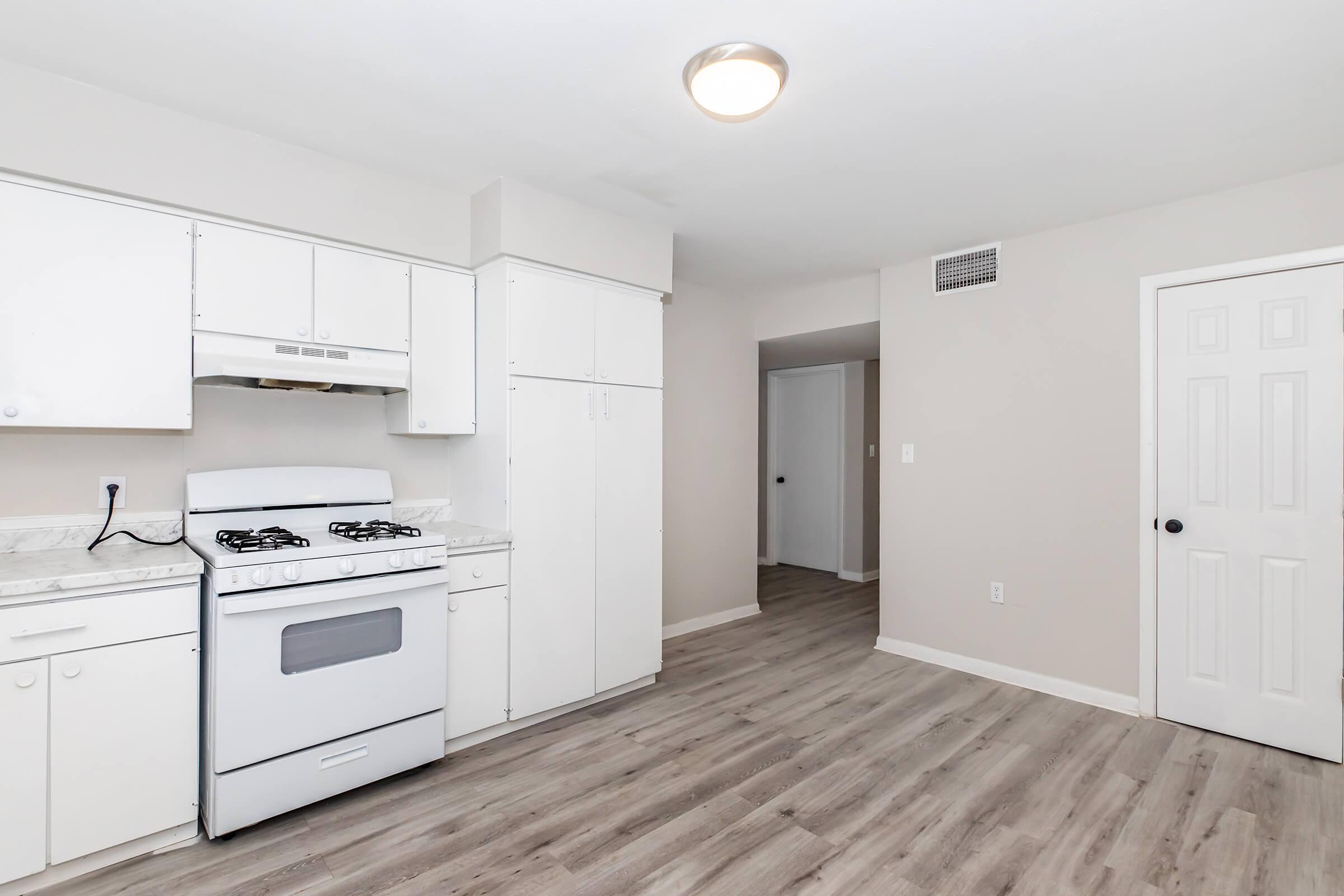 a kitchen with a stove top oven