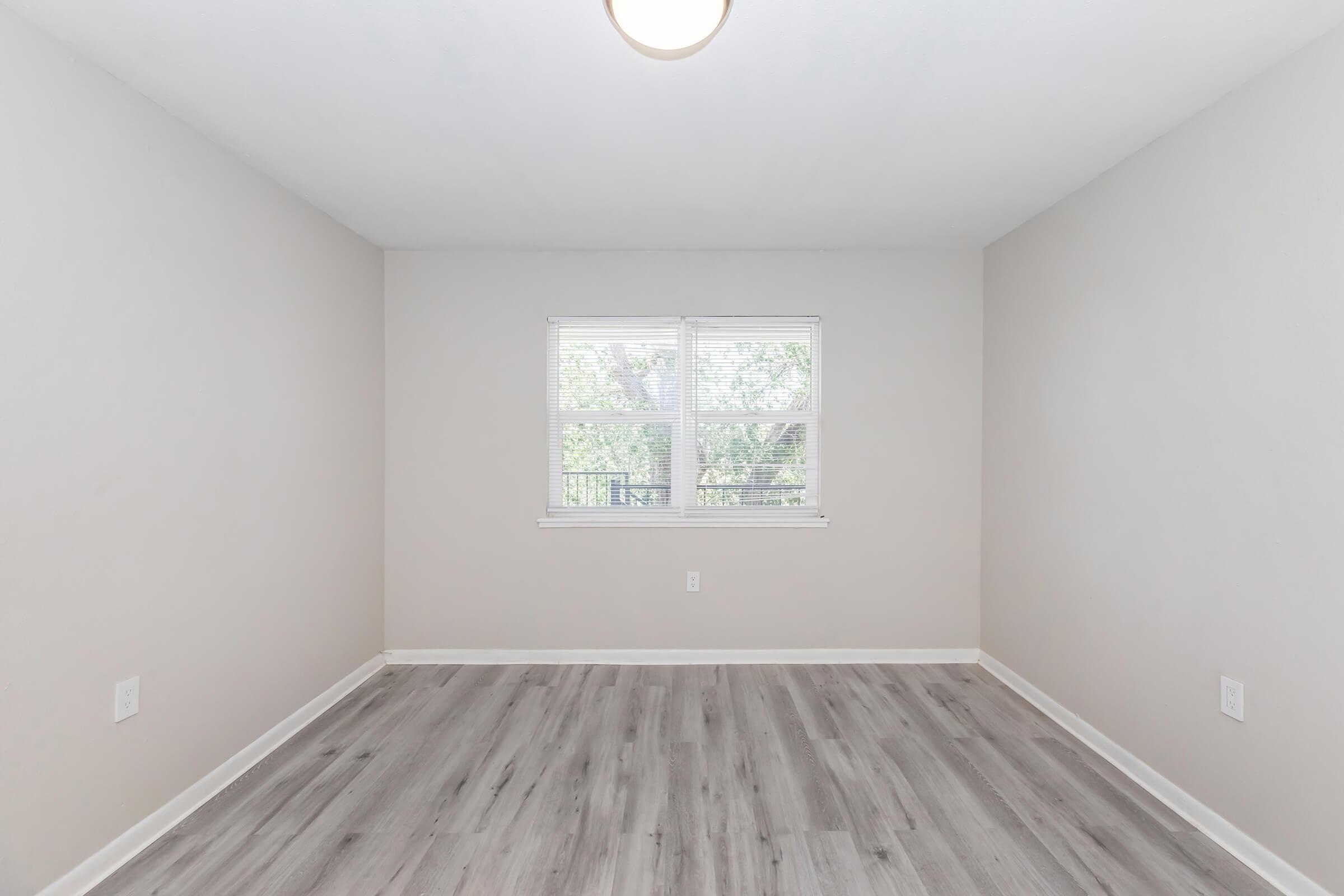 a close up of a hard wood floor next to a window