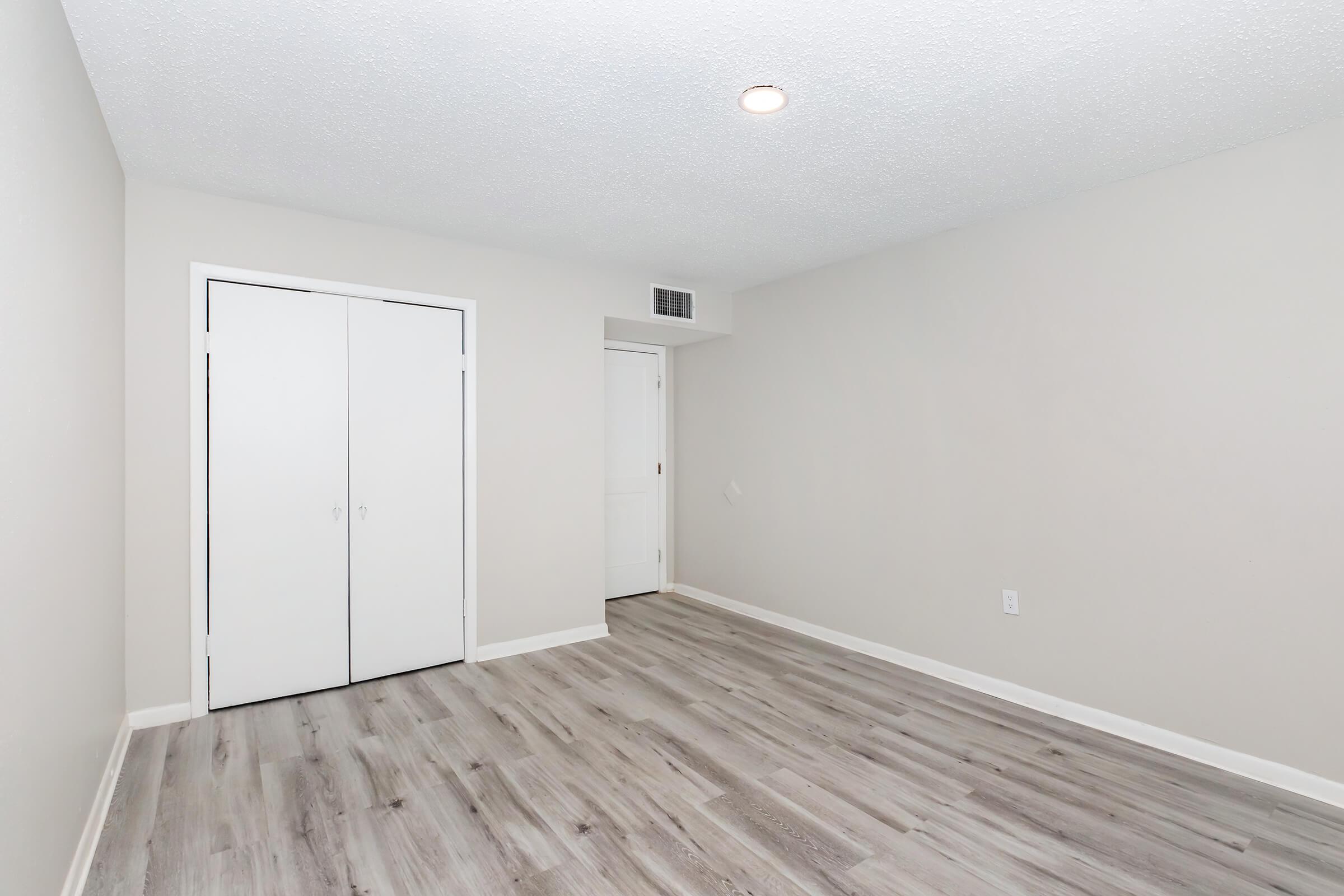 a large empty room with a wooden floor