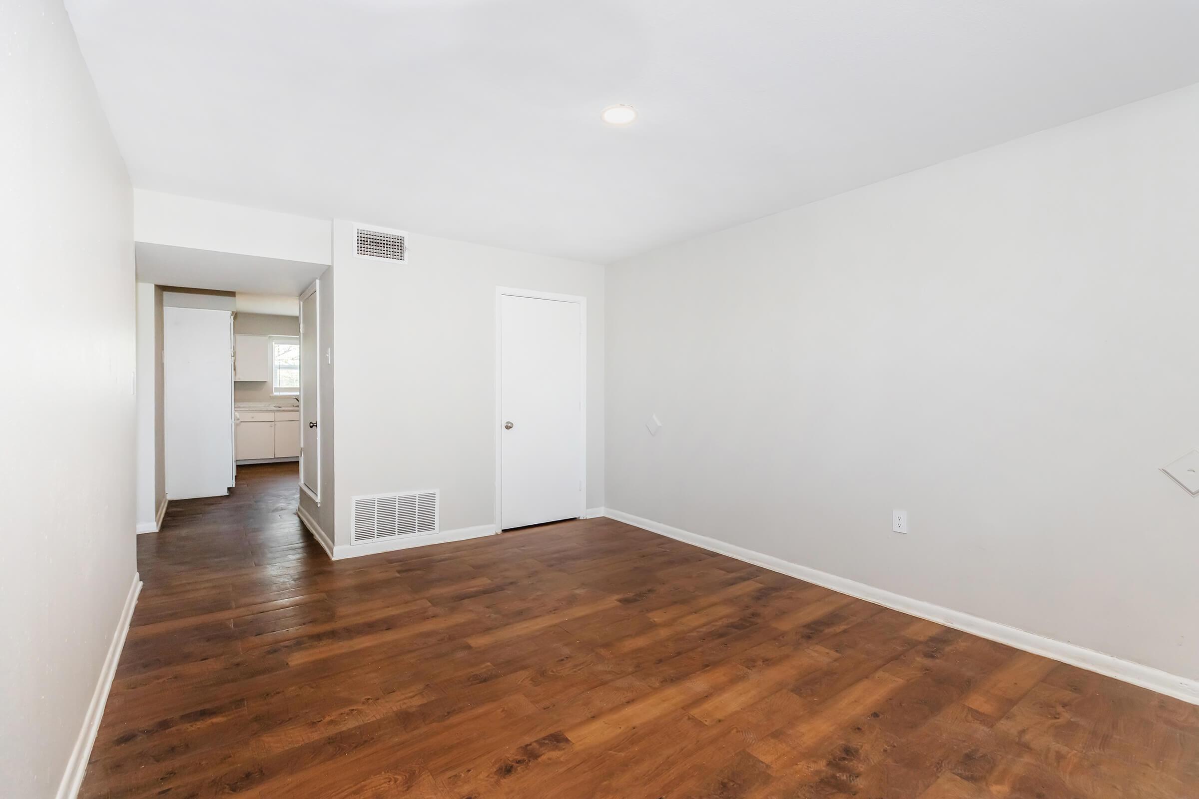 a large empty room with a wood floor