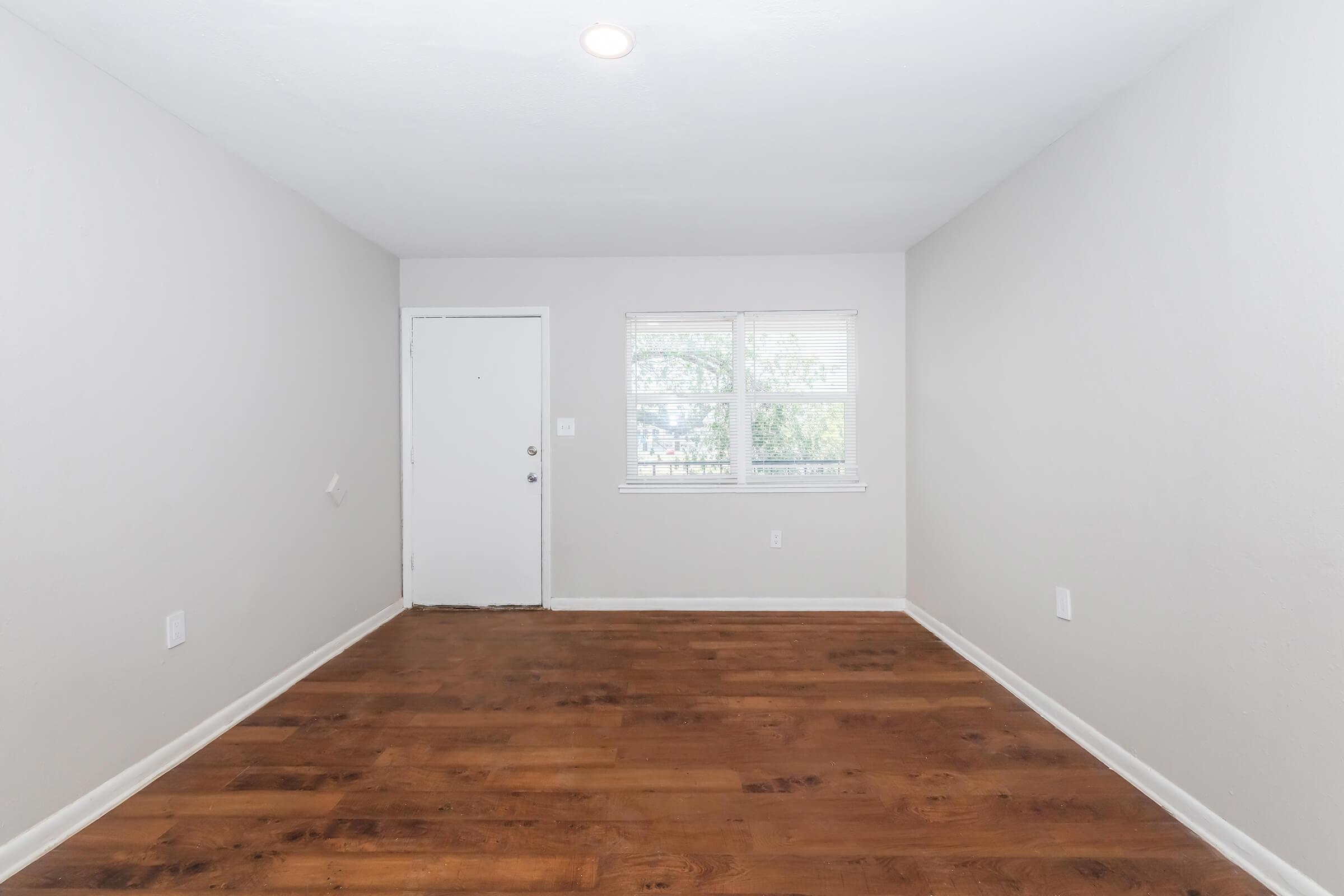 a large empty room with a wooden floor