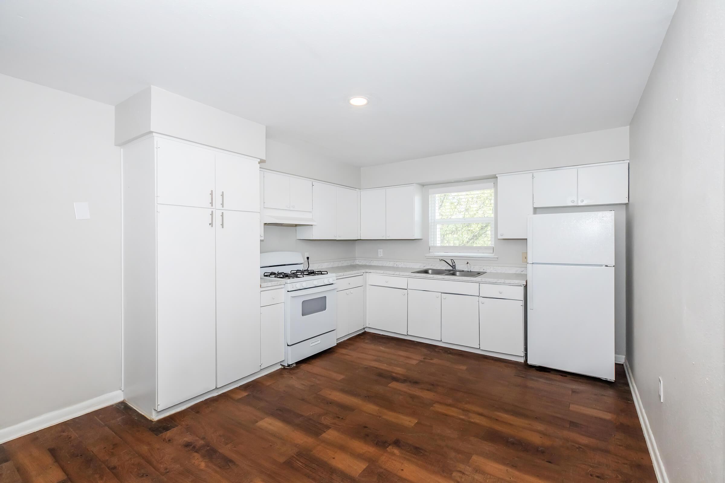 a kitchen with a wood floor