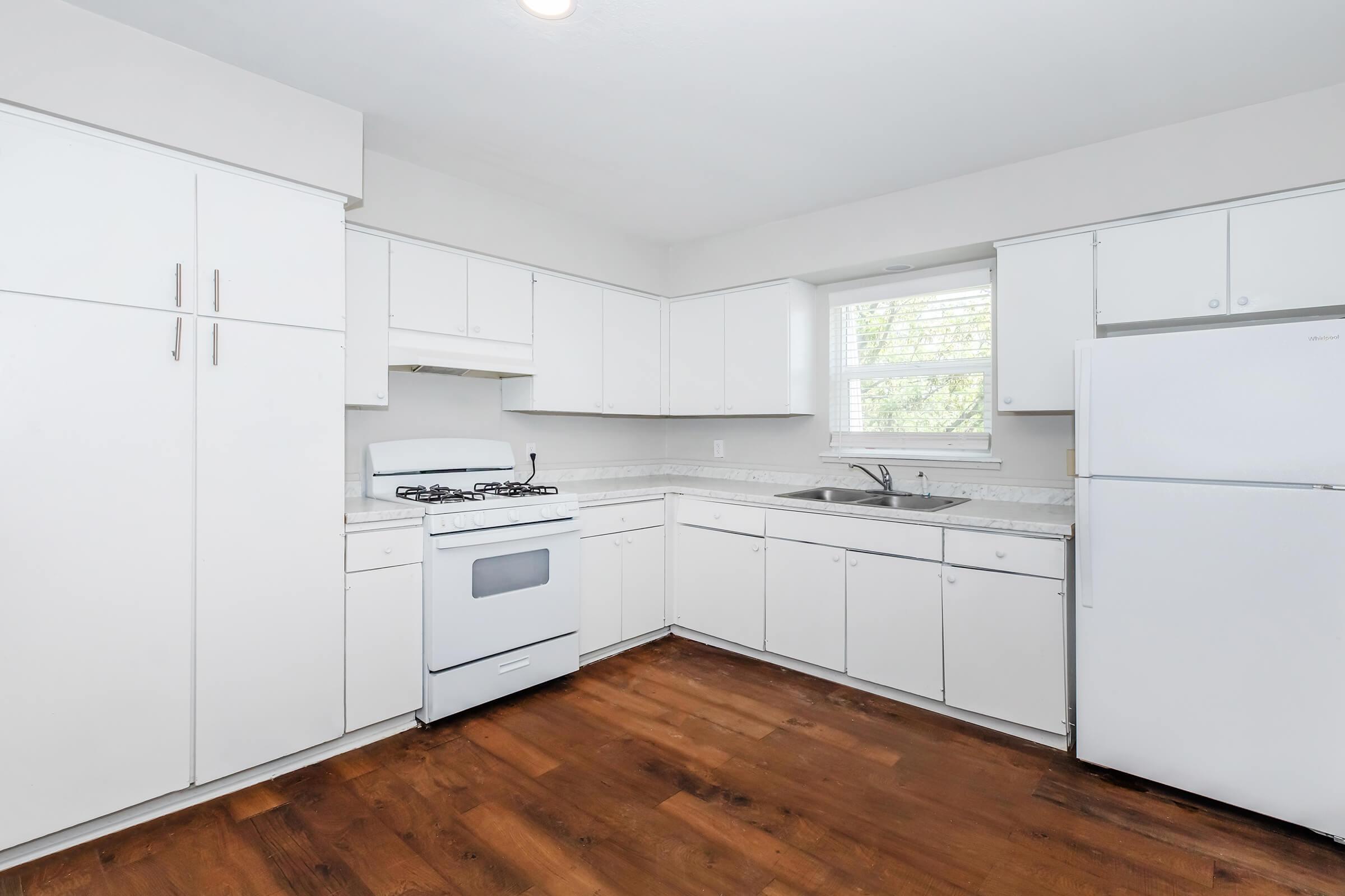 a kitchen with a stove and a refrigerator