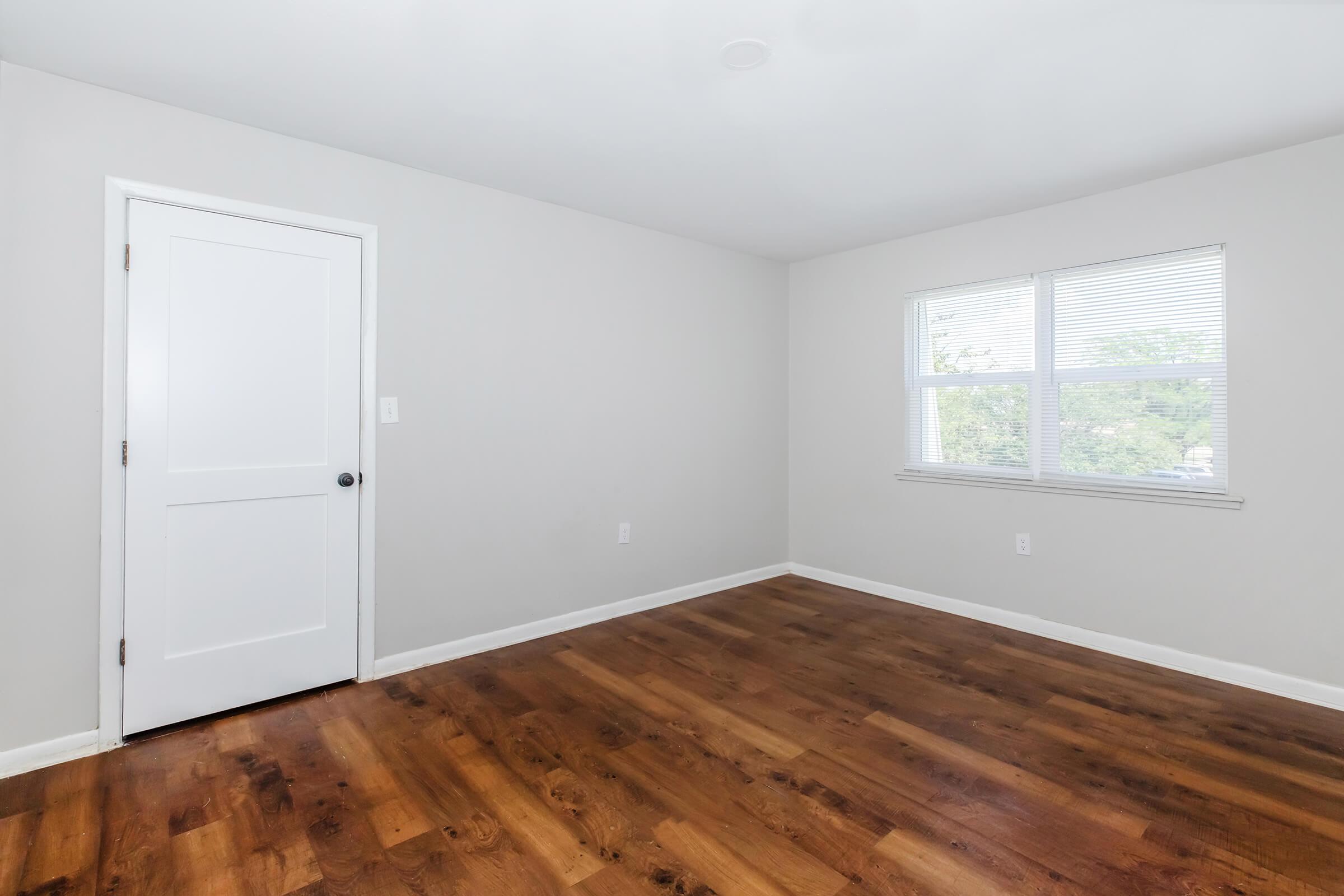 a large empty room with a wooden floor