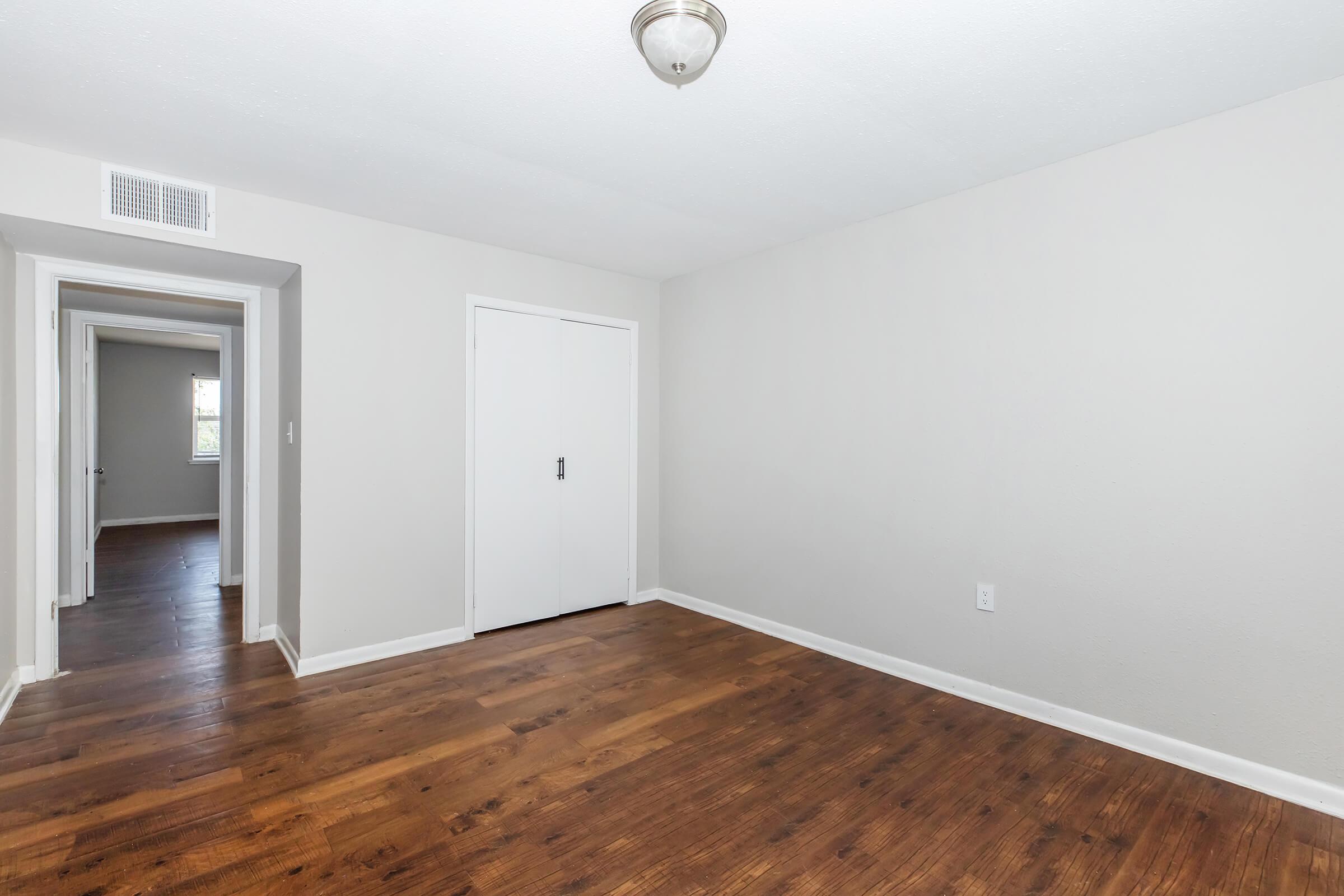 a large empty room with a wood floor