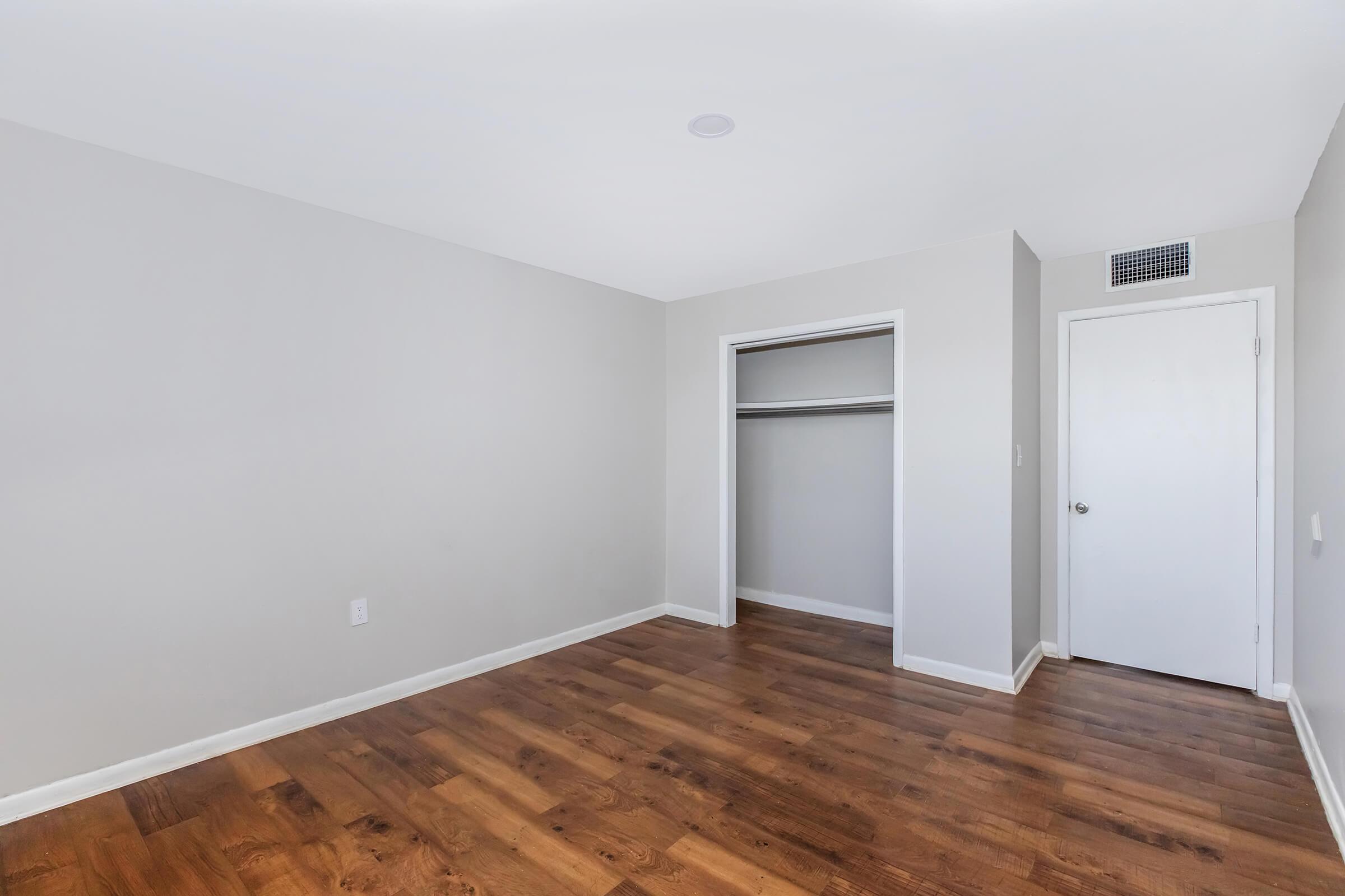 a large empty room with a wood floor