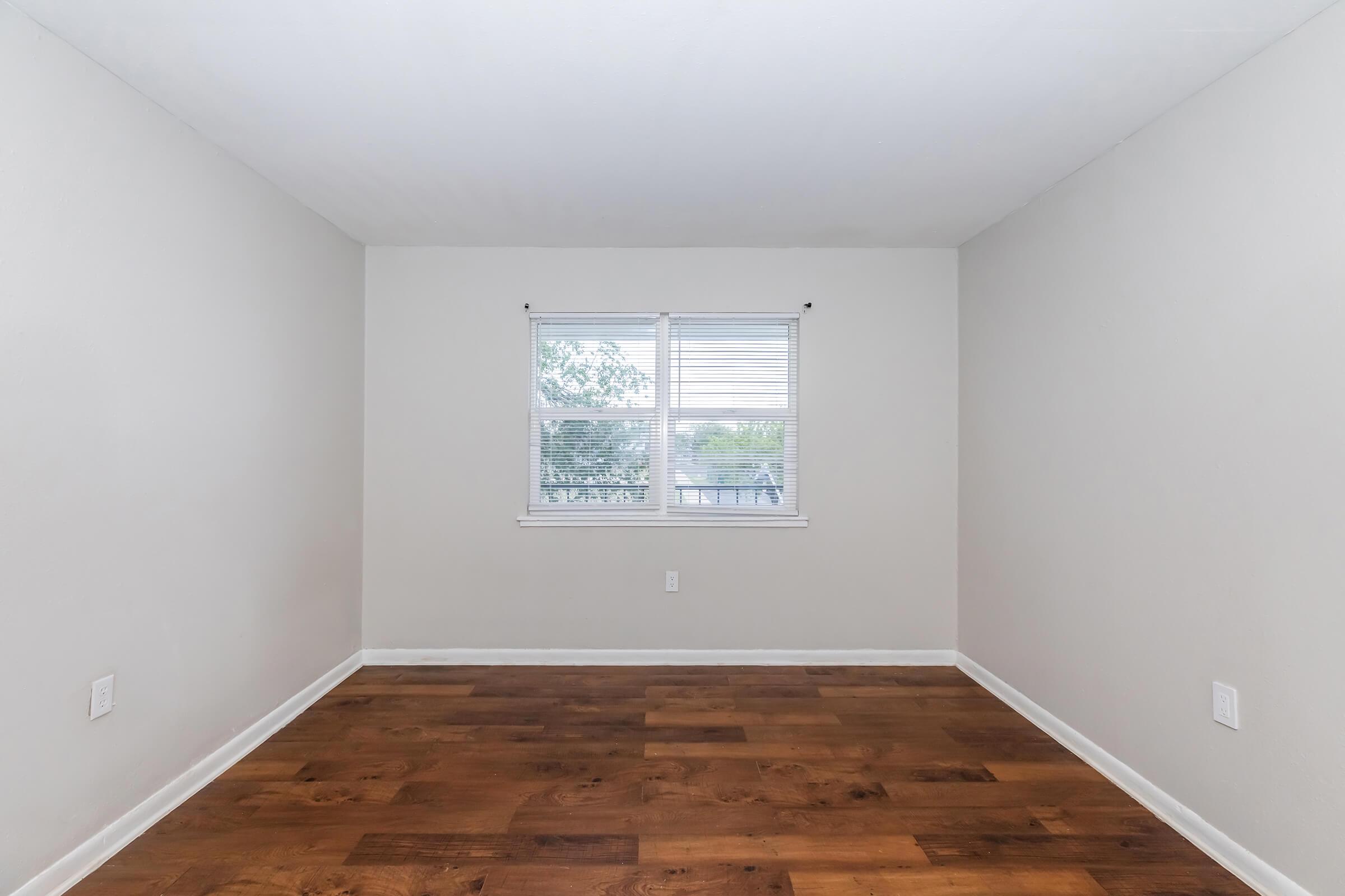 a large empty room with a wooden floor