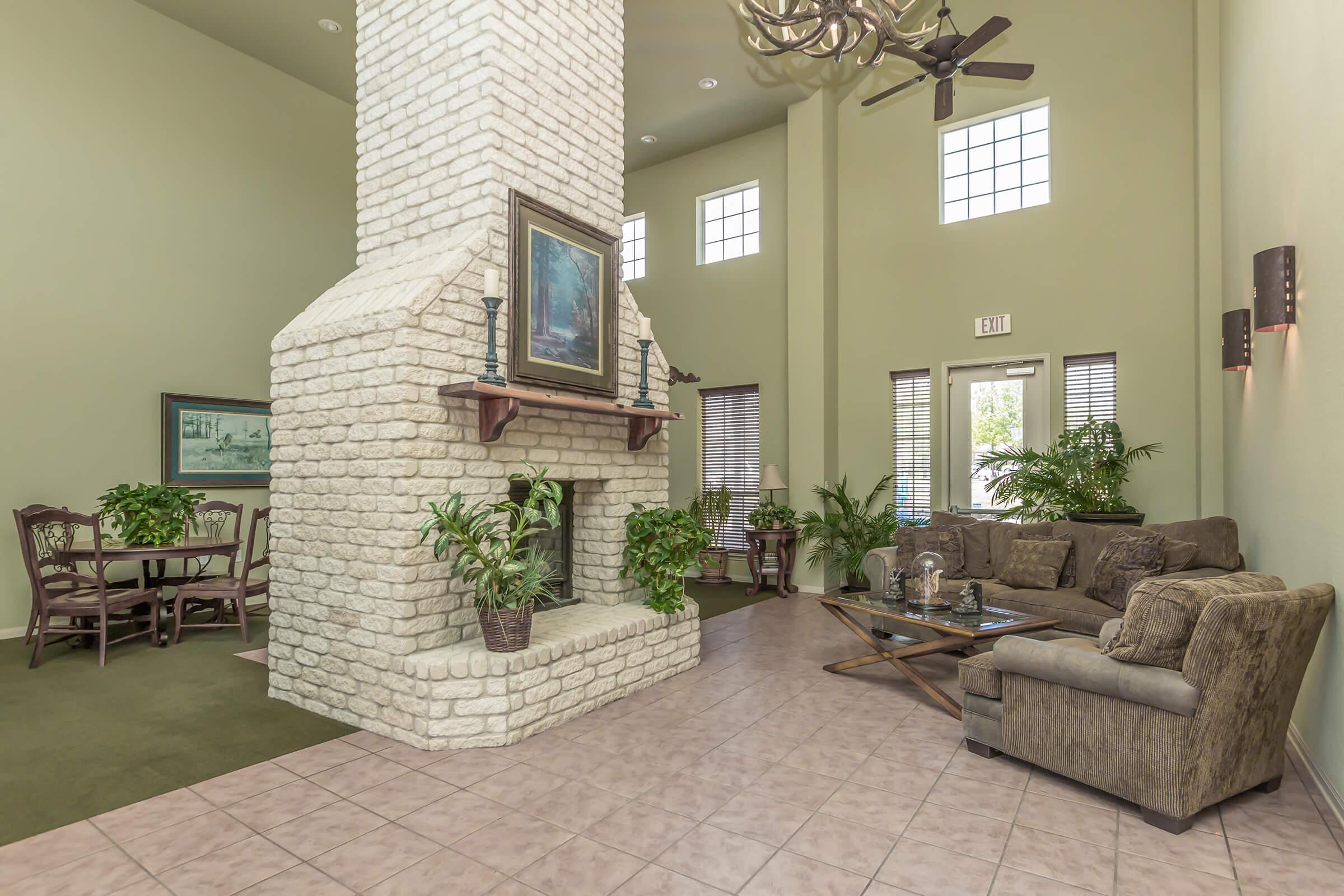 a living room filled with furniture and a fireplace